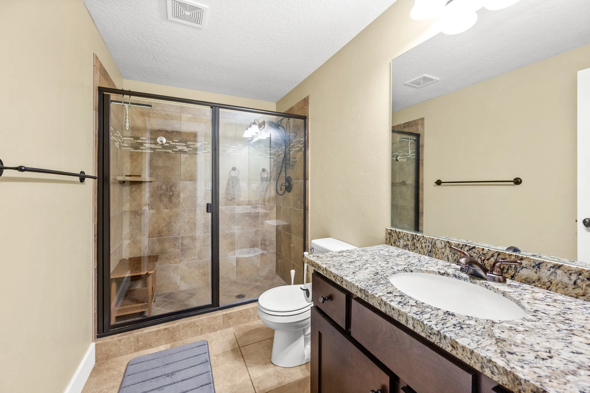 Glass-enclosed shower with tiled walls and a built-in shower niche