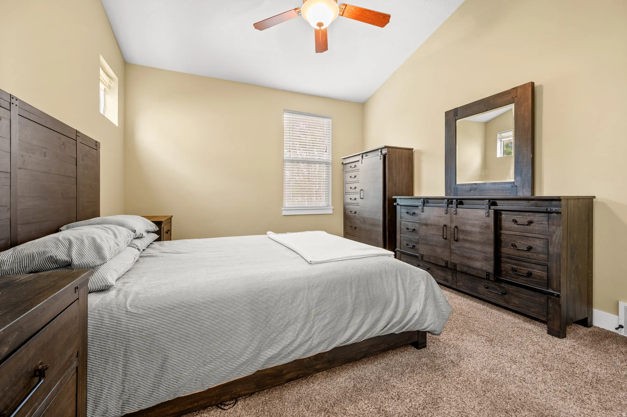 Spacious master bedroom featuring, neutral wall tones, and plush carpeting