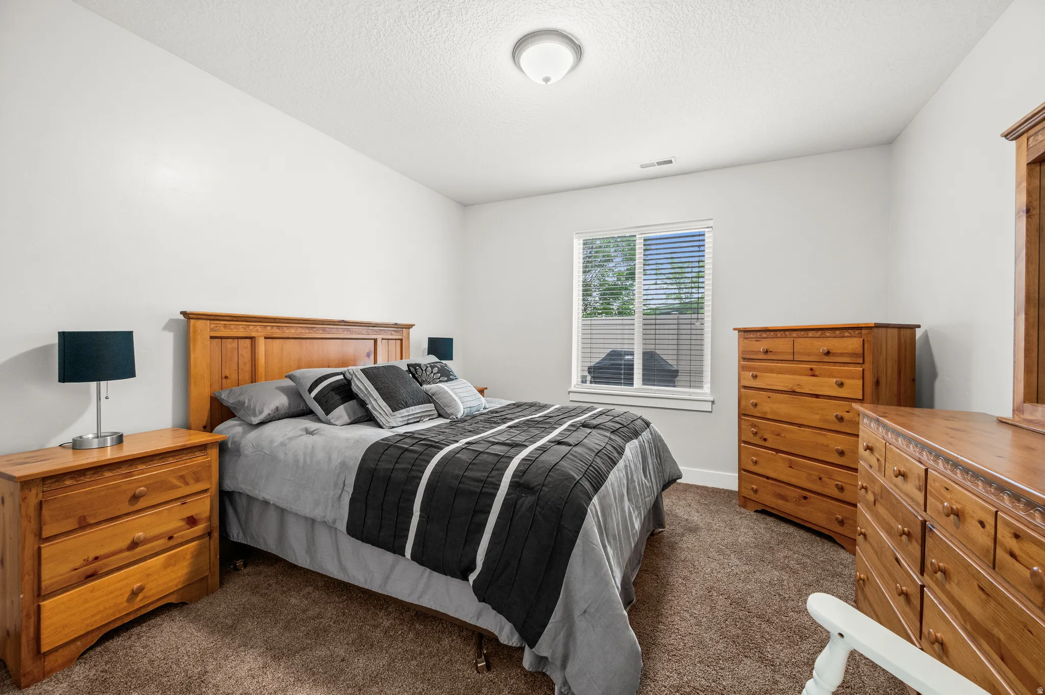 Bedroom 2 featuring a double-pane window and  horizontal blinds