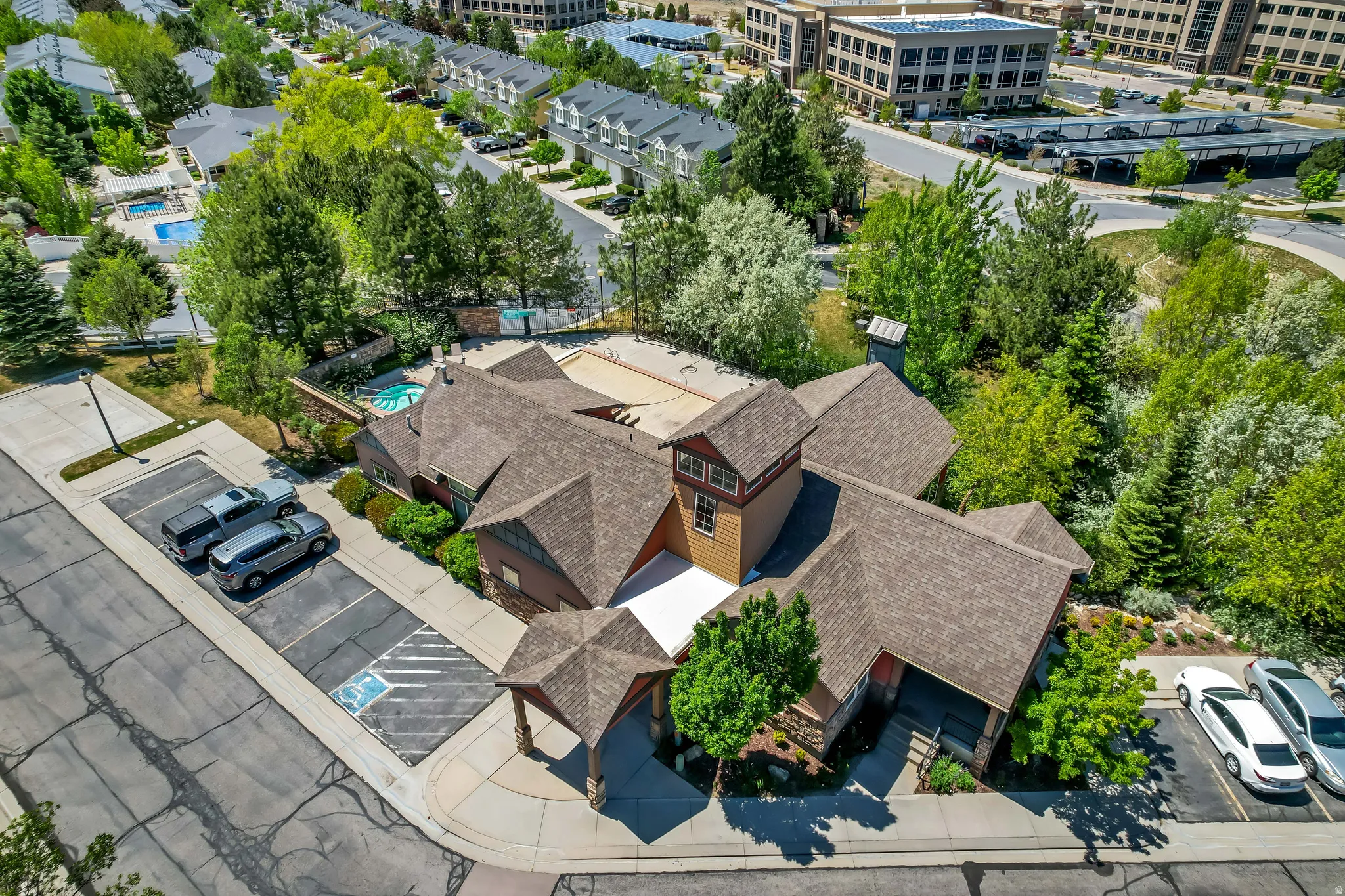Clubhouse building with multiple gabled roofs, stone and wood siding, and a prominent cupola