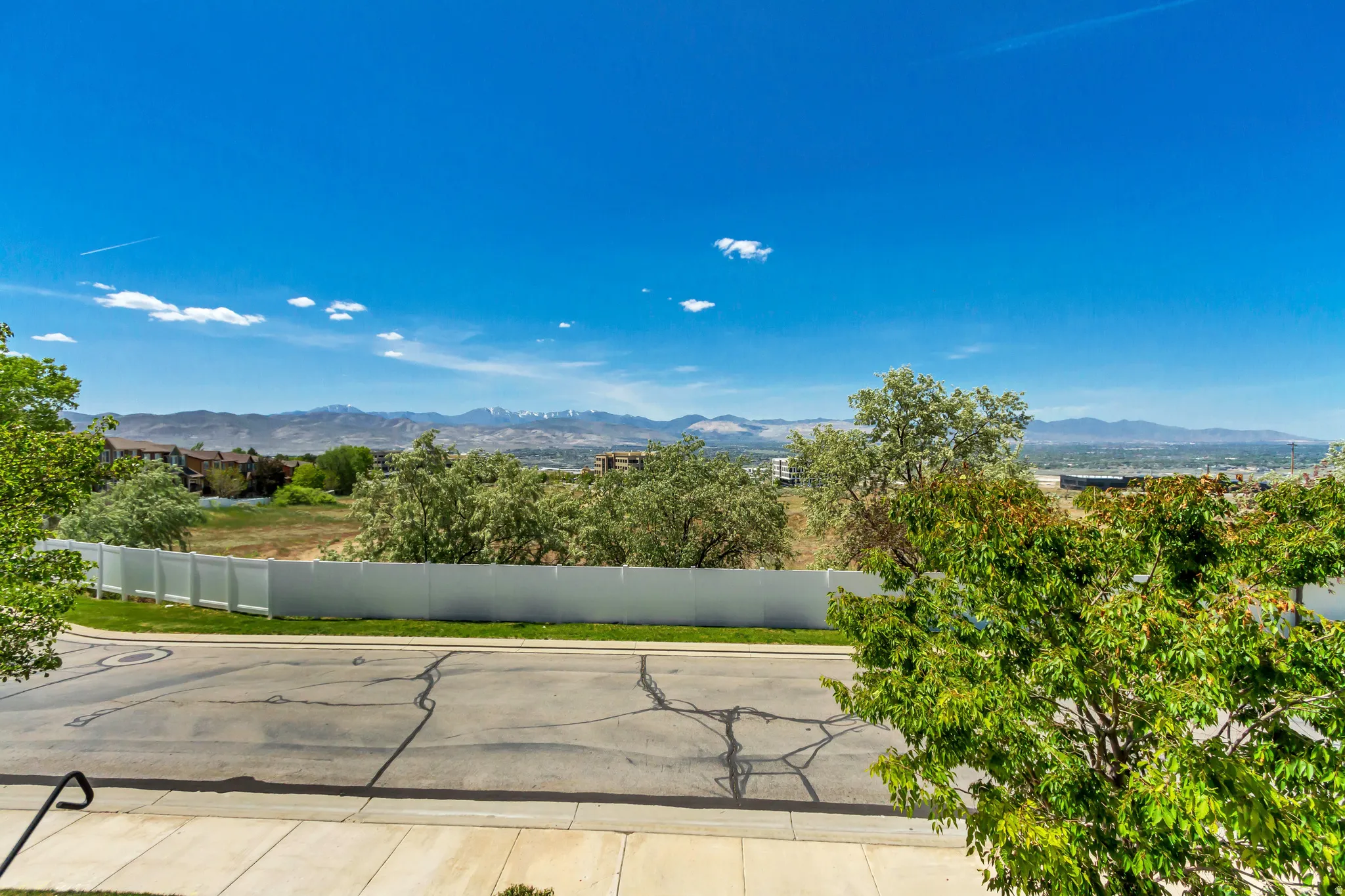View from primary bedroom includes an expansive mountain range backdrop and clear blue sky