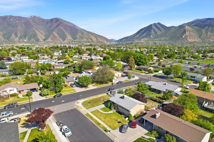 Aerial view of a residential neighborhood with a mountainous backdrop