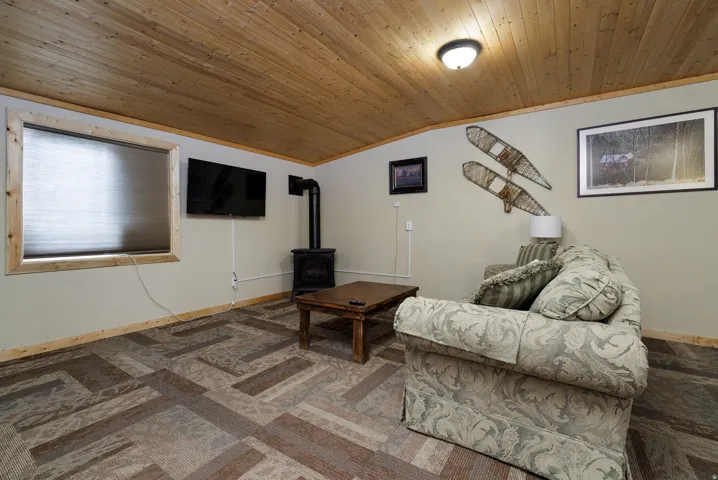 Recessed wood-finish plank ceiling with a flush-mount light fixture