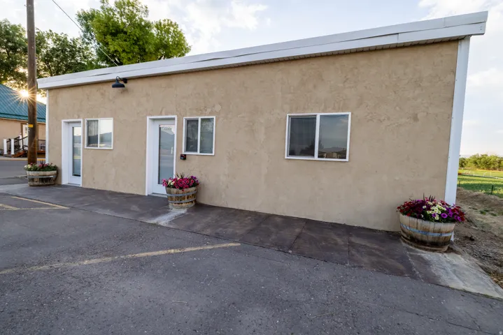 Stucco exterior featuring multiple entry points and white-framed windows