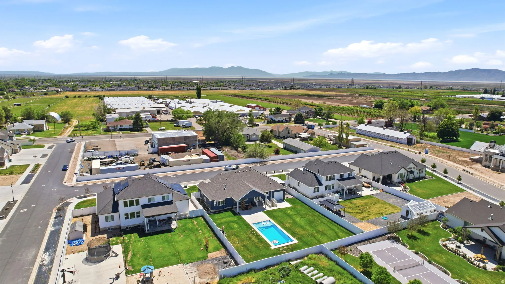 Aerial perspective showcasing a residential neighborhood with distant mountains