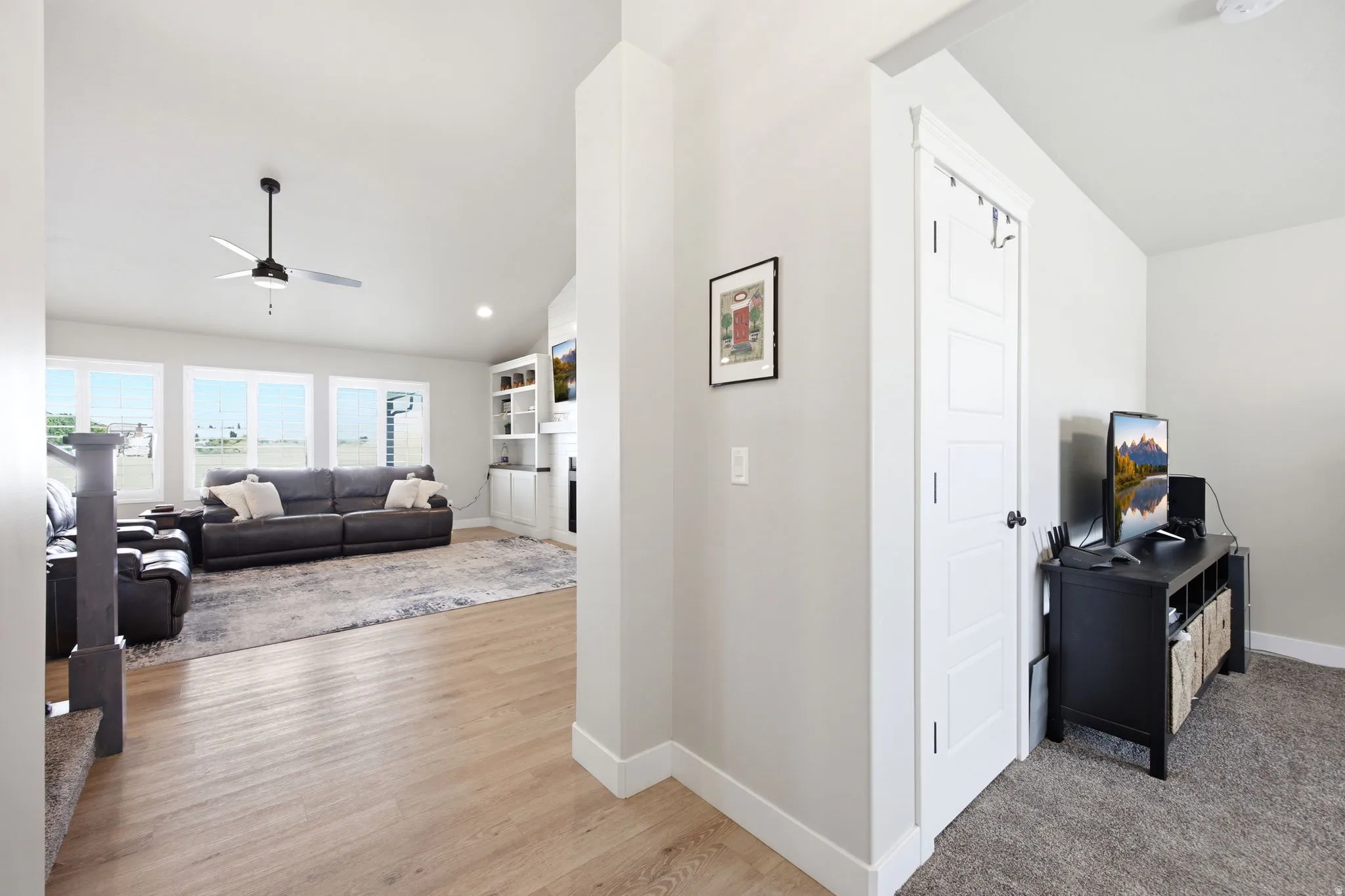 Open-concept living space with wood-finish flooring extending into the main area