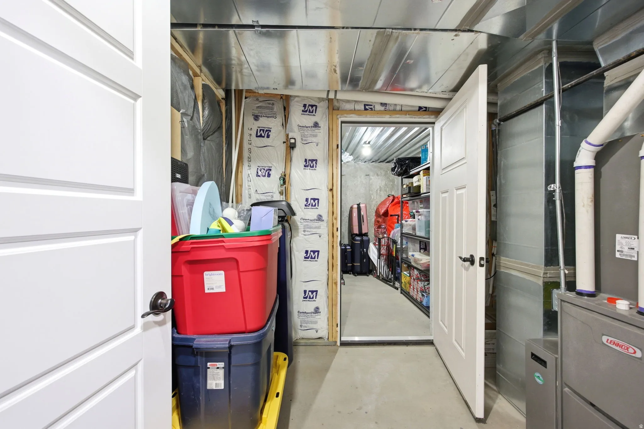Utility area featuring exposed ductwork, a Lennox HVAC unit, and a concrete floor