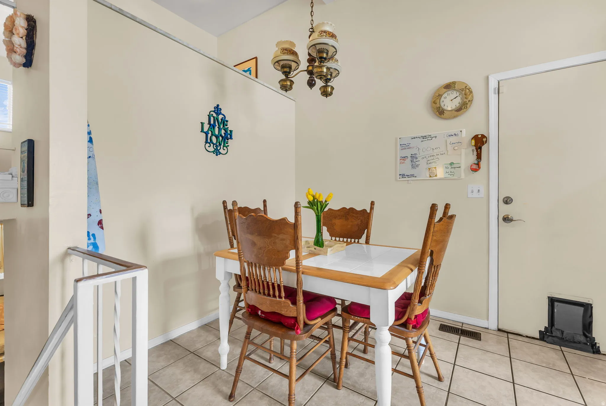 Tile flooring with a pet door, a built-in partition wall, and an overhead light fixture