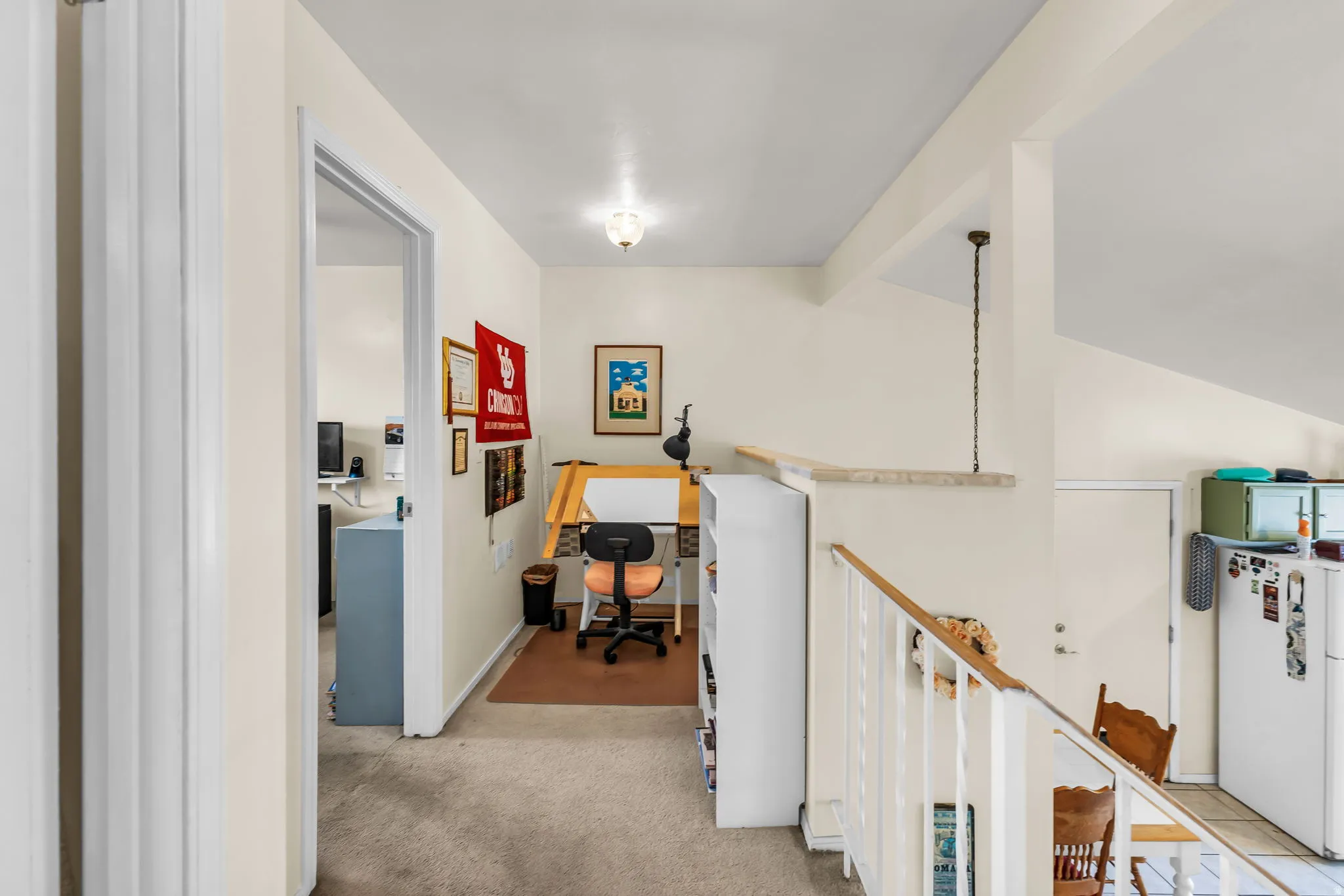 Open landing area featuring carpeted flooring and neutral wall tones
