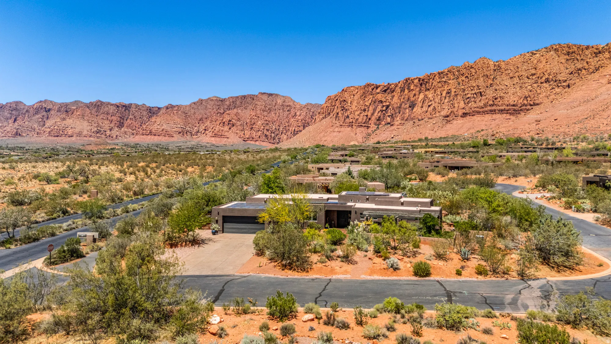Desert landscape featuring a contemporary flat-roof residence