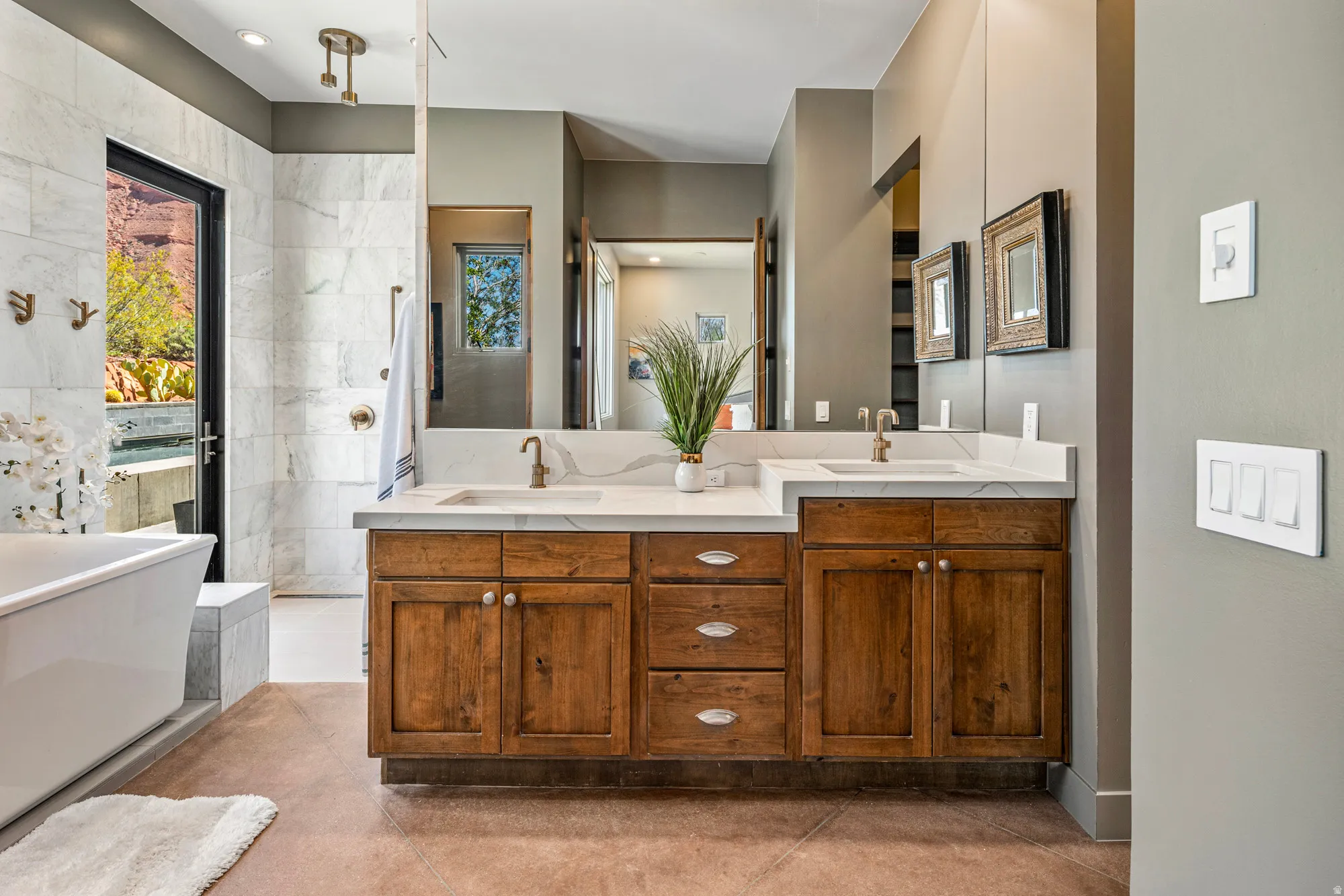 Dual vanity with wood cabinetry and white stone countertops