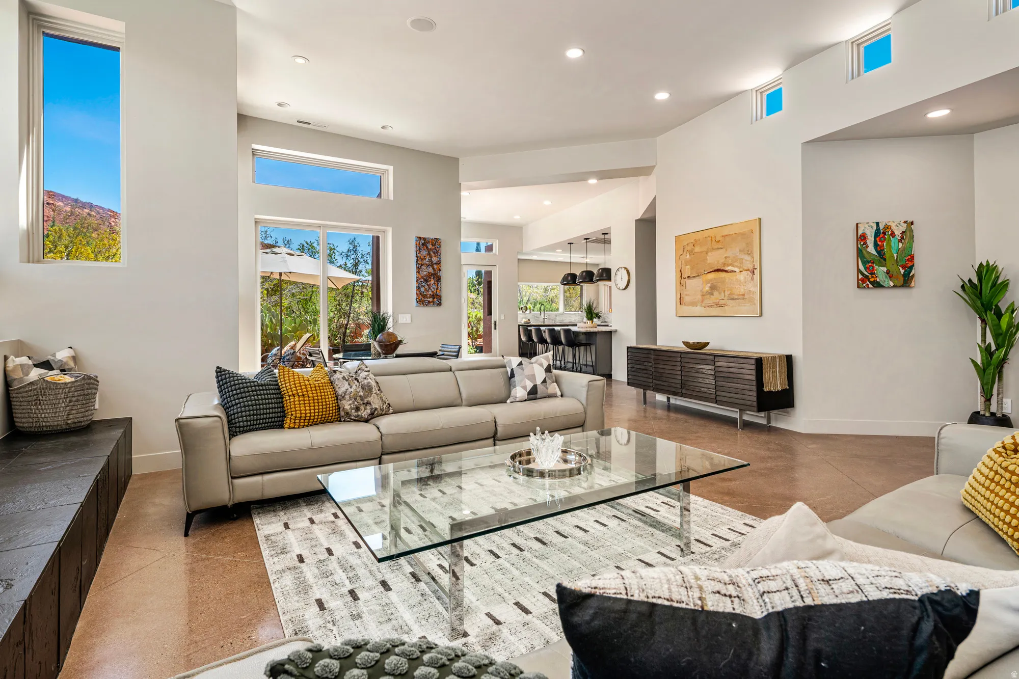 Spacious living area featuring high ceilings, recessed lighting, and large windows