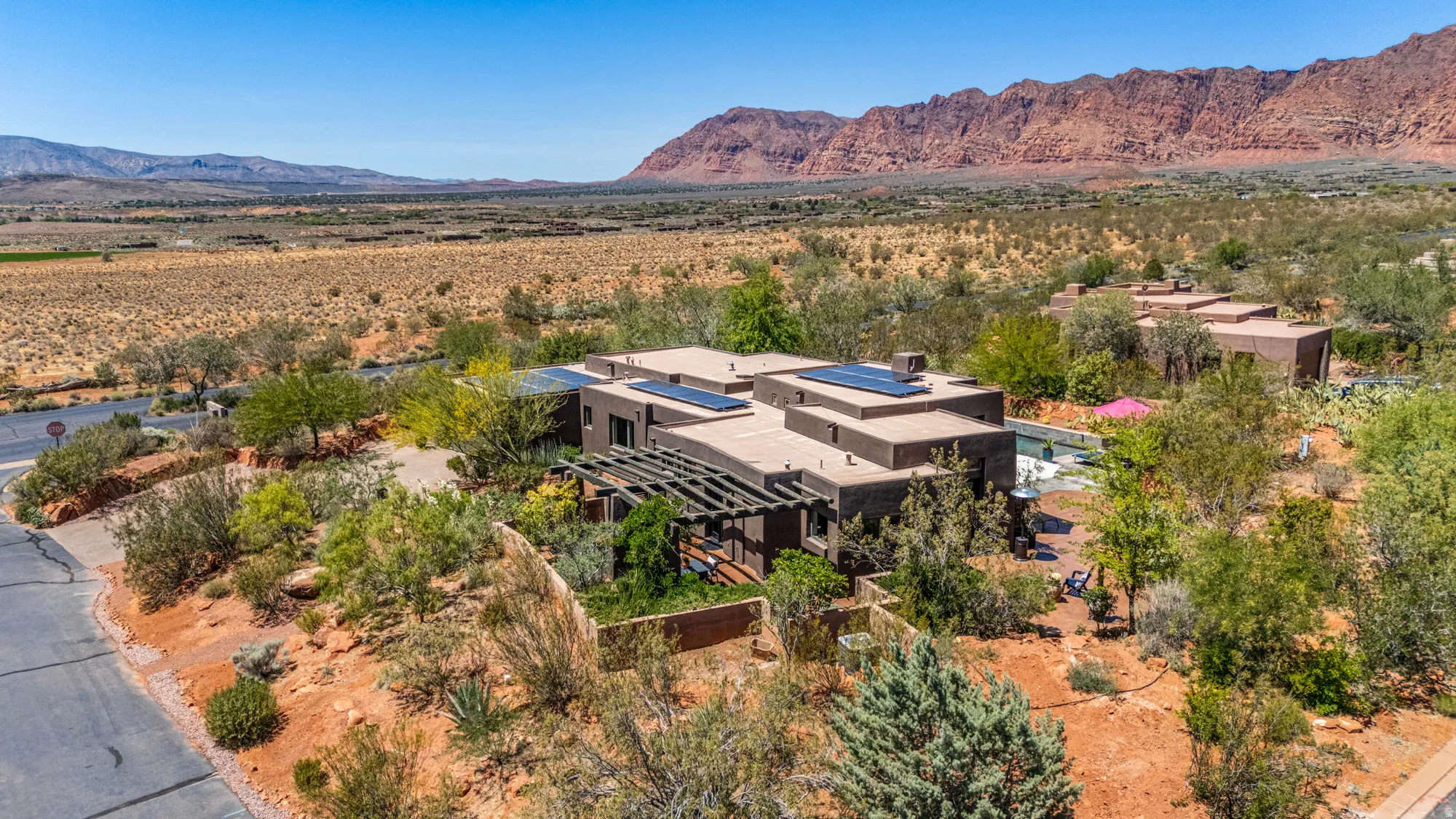 Modern architectural residence featuring a flat roofline and integrated solar panels