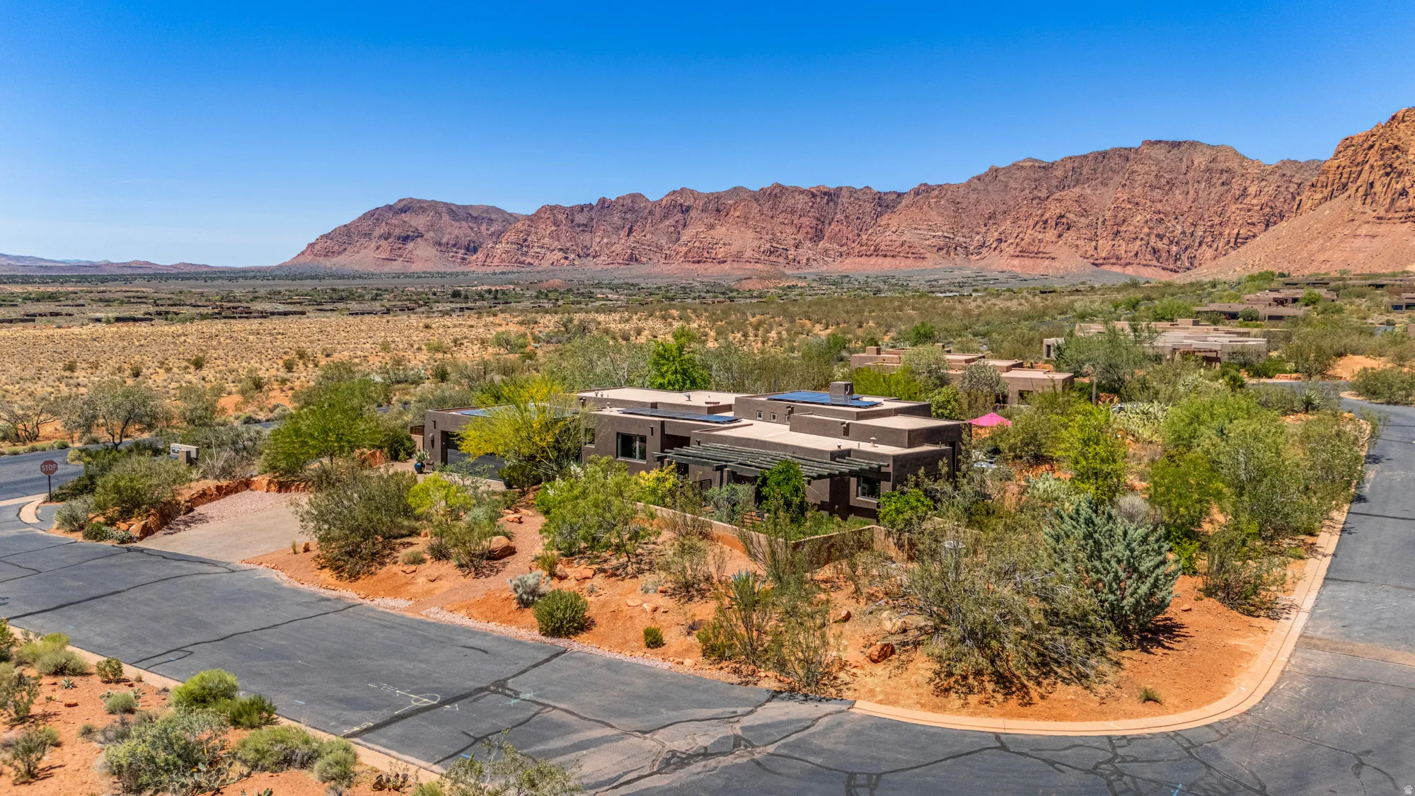 Single-story desert contemporary residence with a flat roofline and integrated solar panels