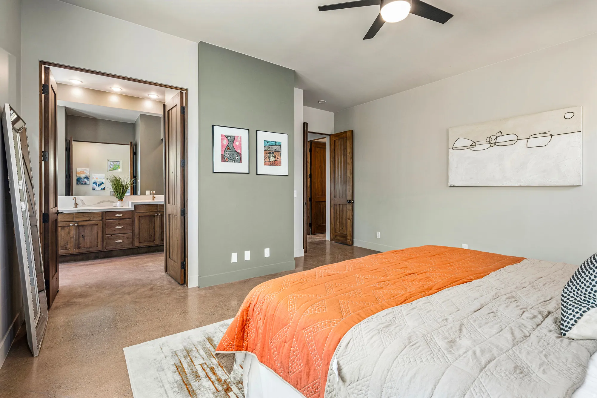 Bedroom featuring concrete flooring and a ceiling fan