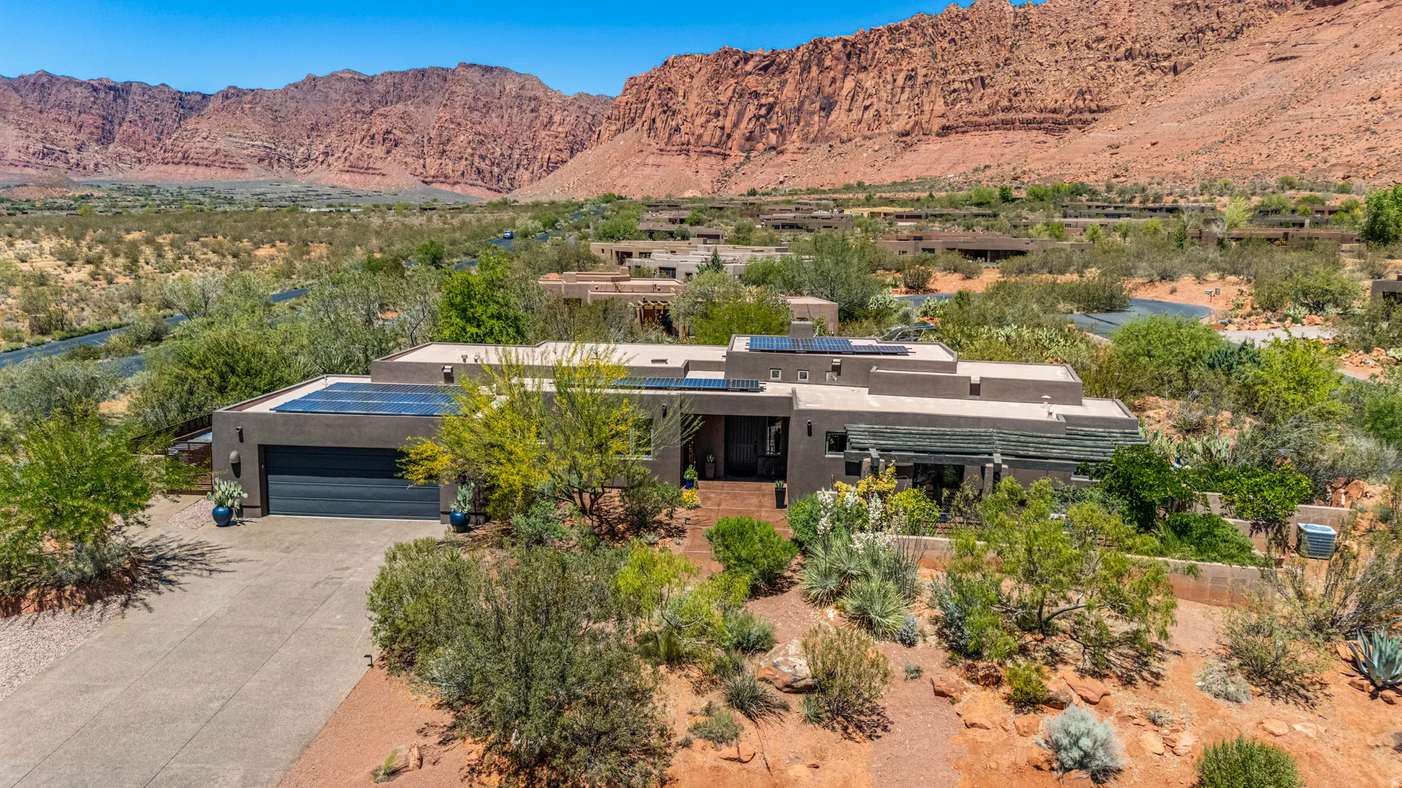 Modern desert architecture featuring a flat roofline and integrated solar panels