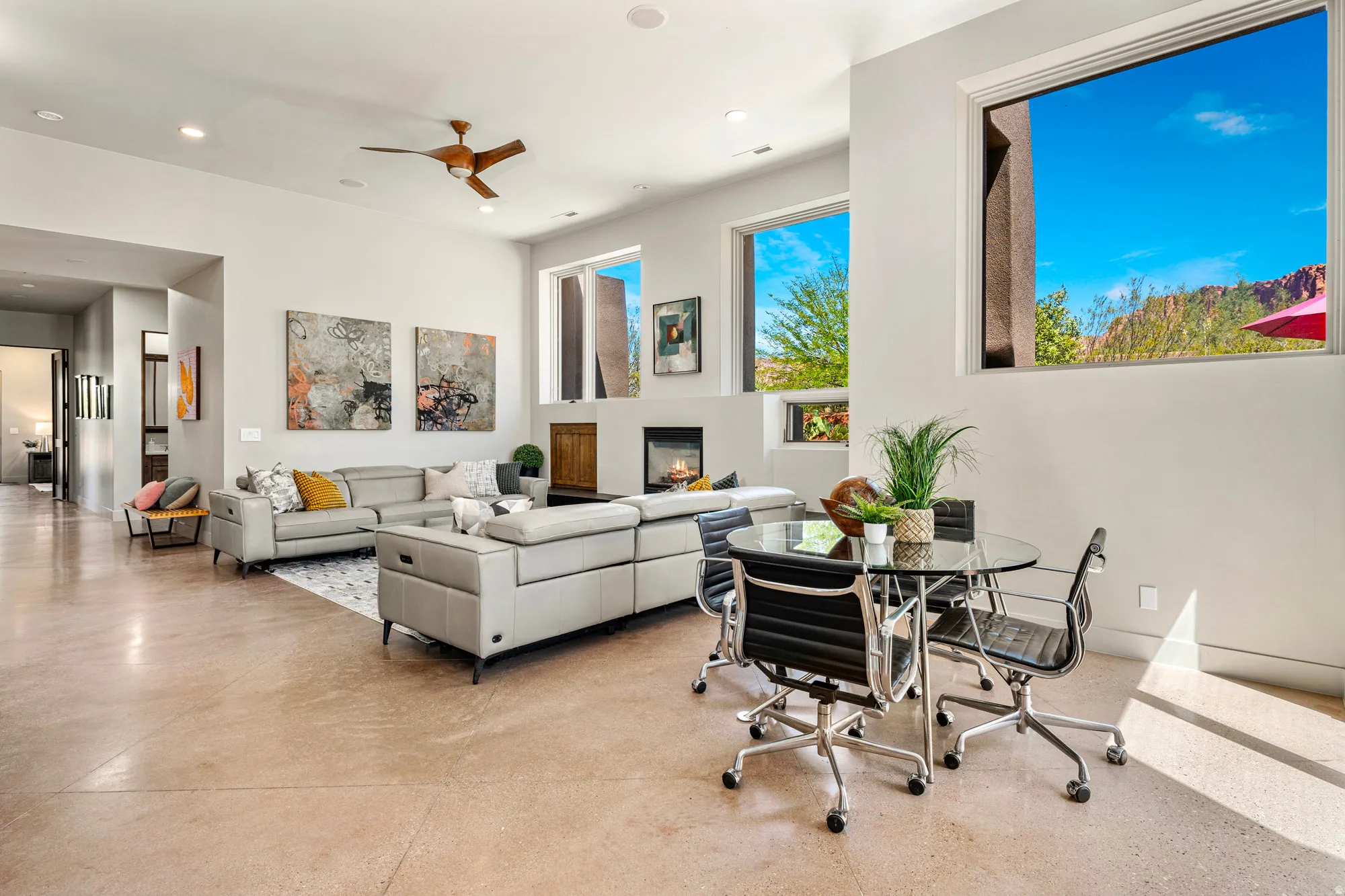 Open-concept living area featuring high ceilings, recessed lighting, and polished concrete flooring