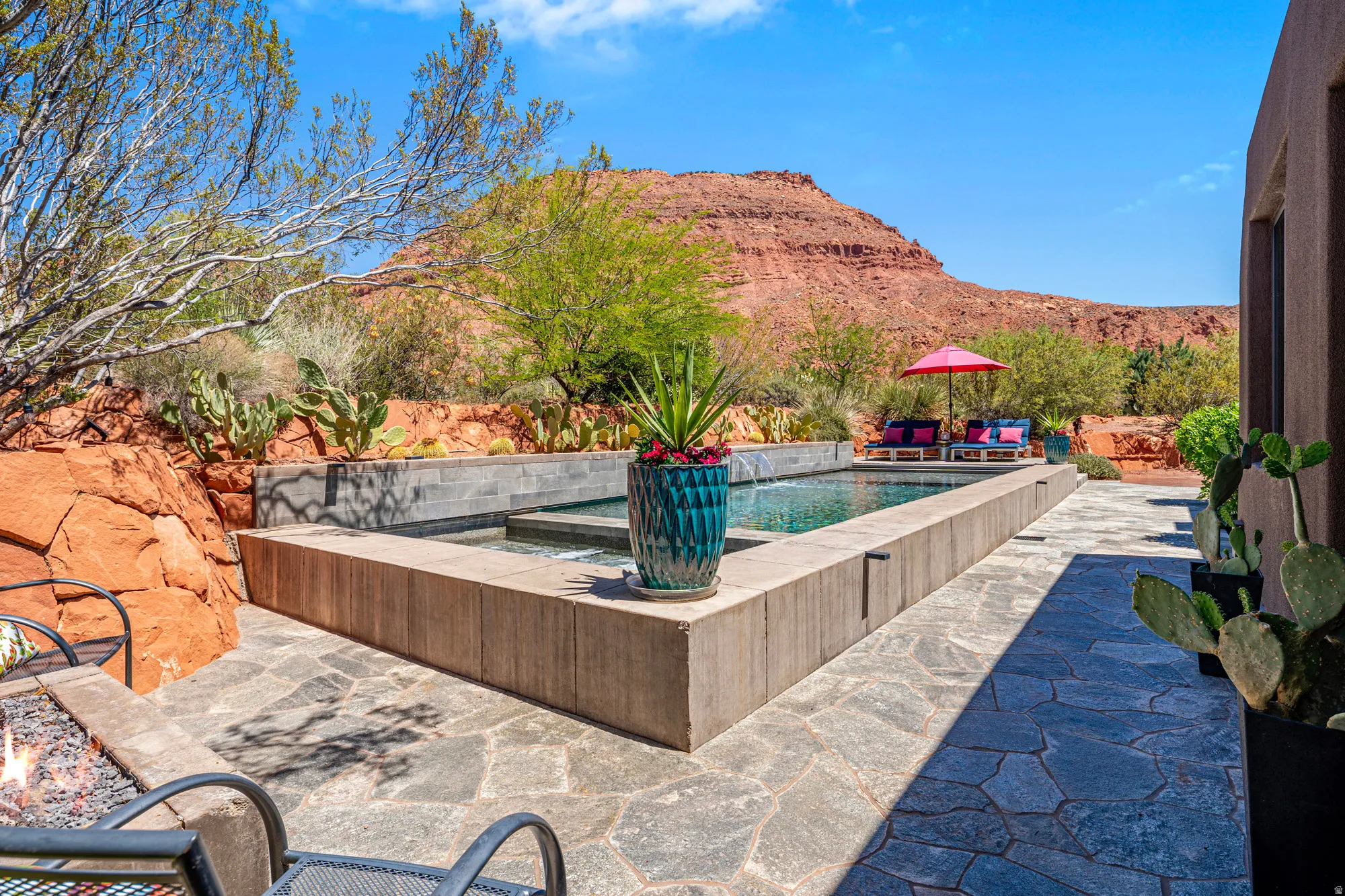 Outdoor living area featuring a rectangular pool and integrated spa