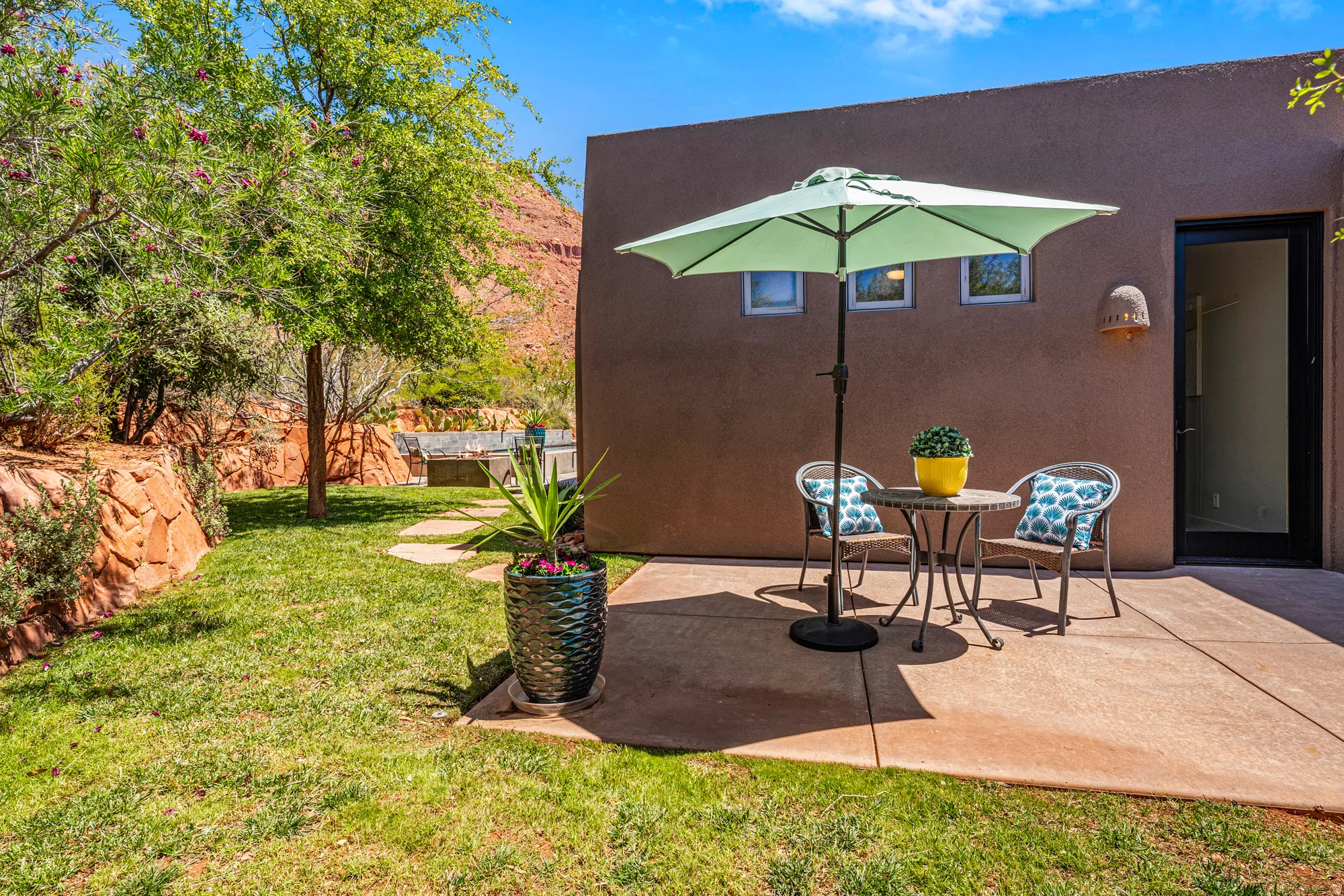 Private patio space featuring a concrete slab, direct exterior access, and three high-set windows