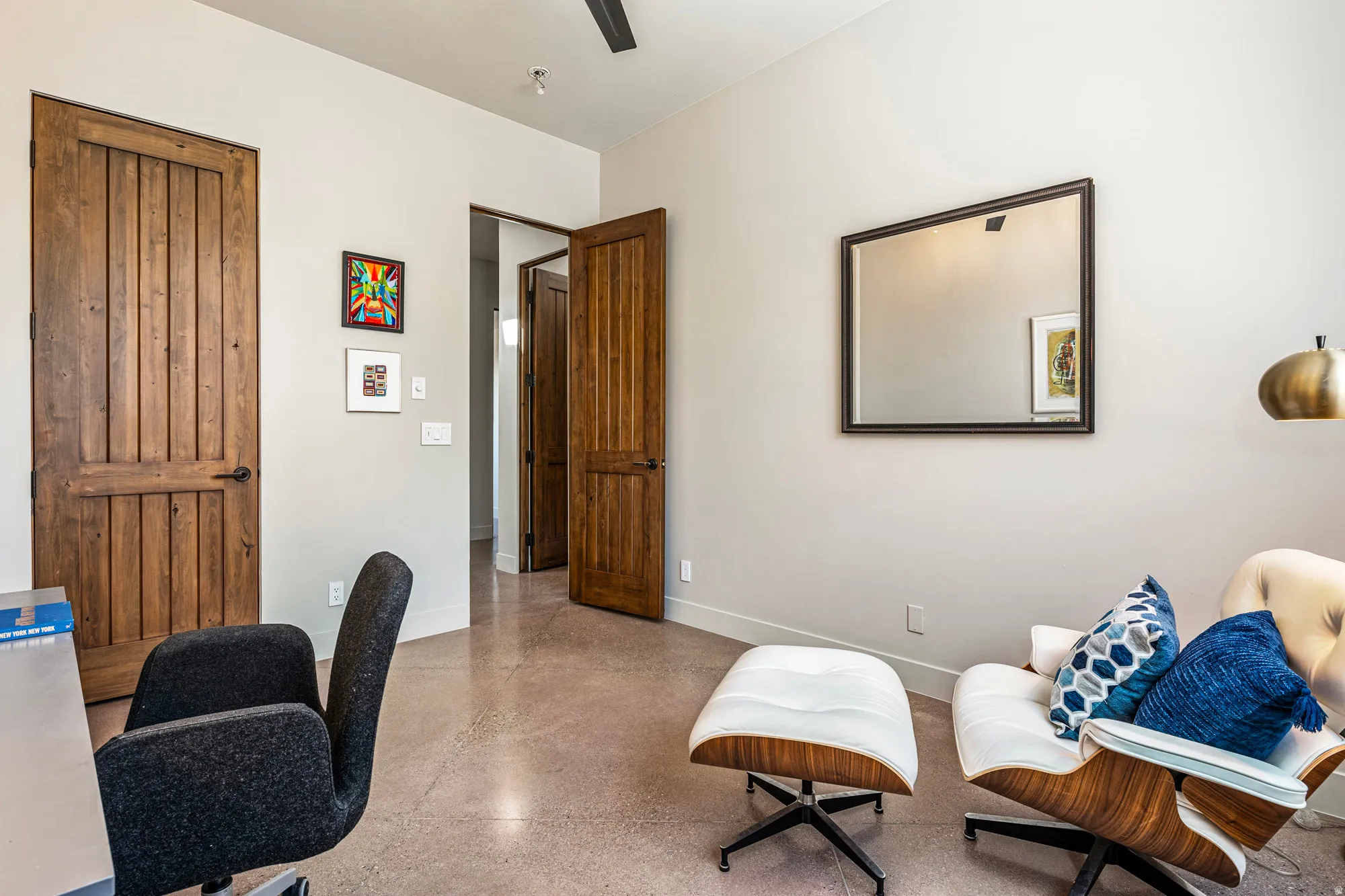 Interior space featuring polished concrete flooring, recessed lighting, and solid wood-paneled doors with dark hardware