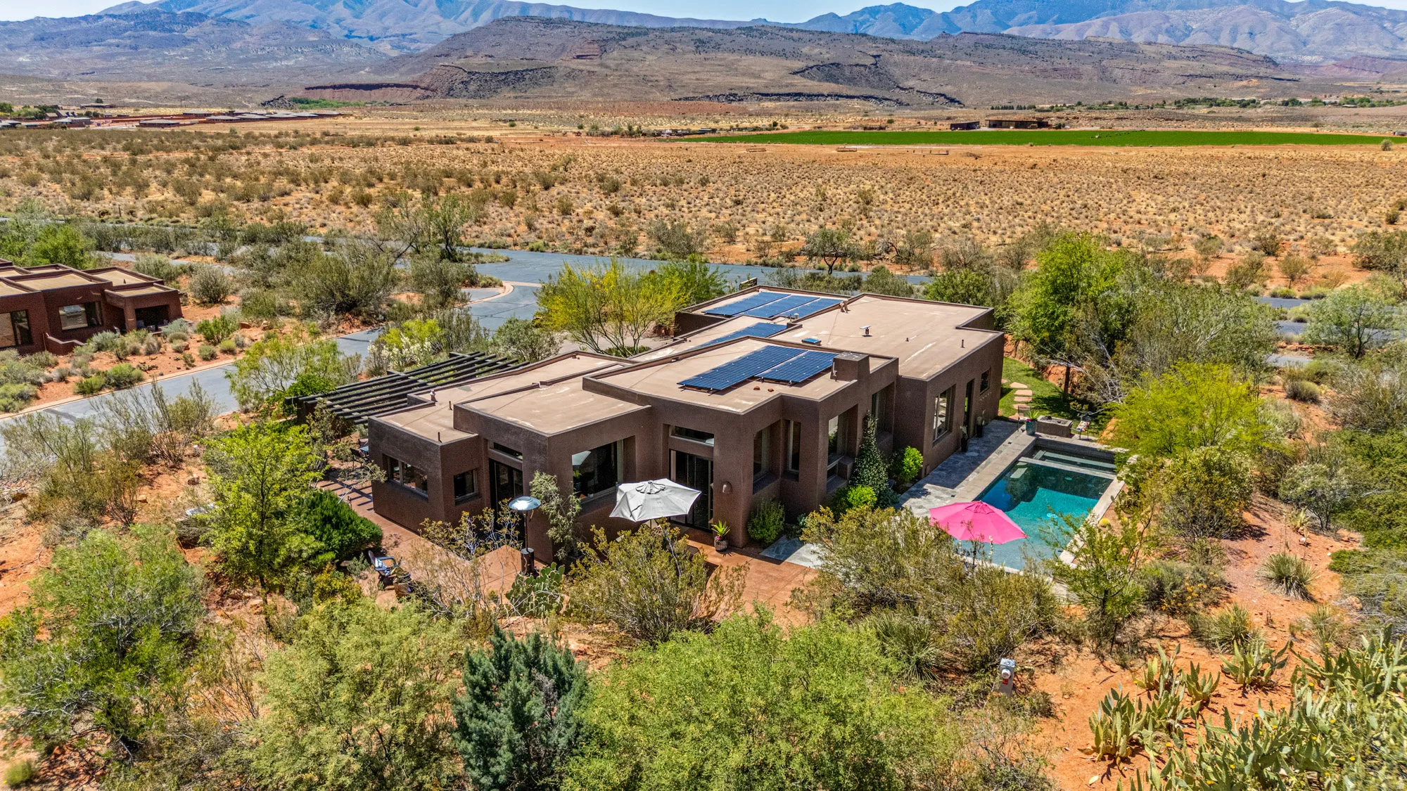 Contemporary desert-style residence featuring a flat roofline and a private swimming pool