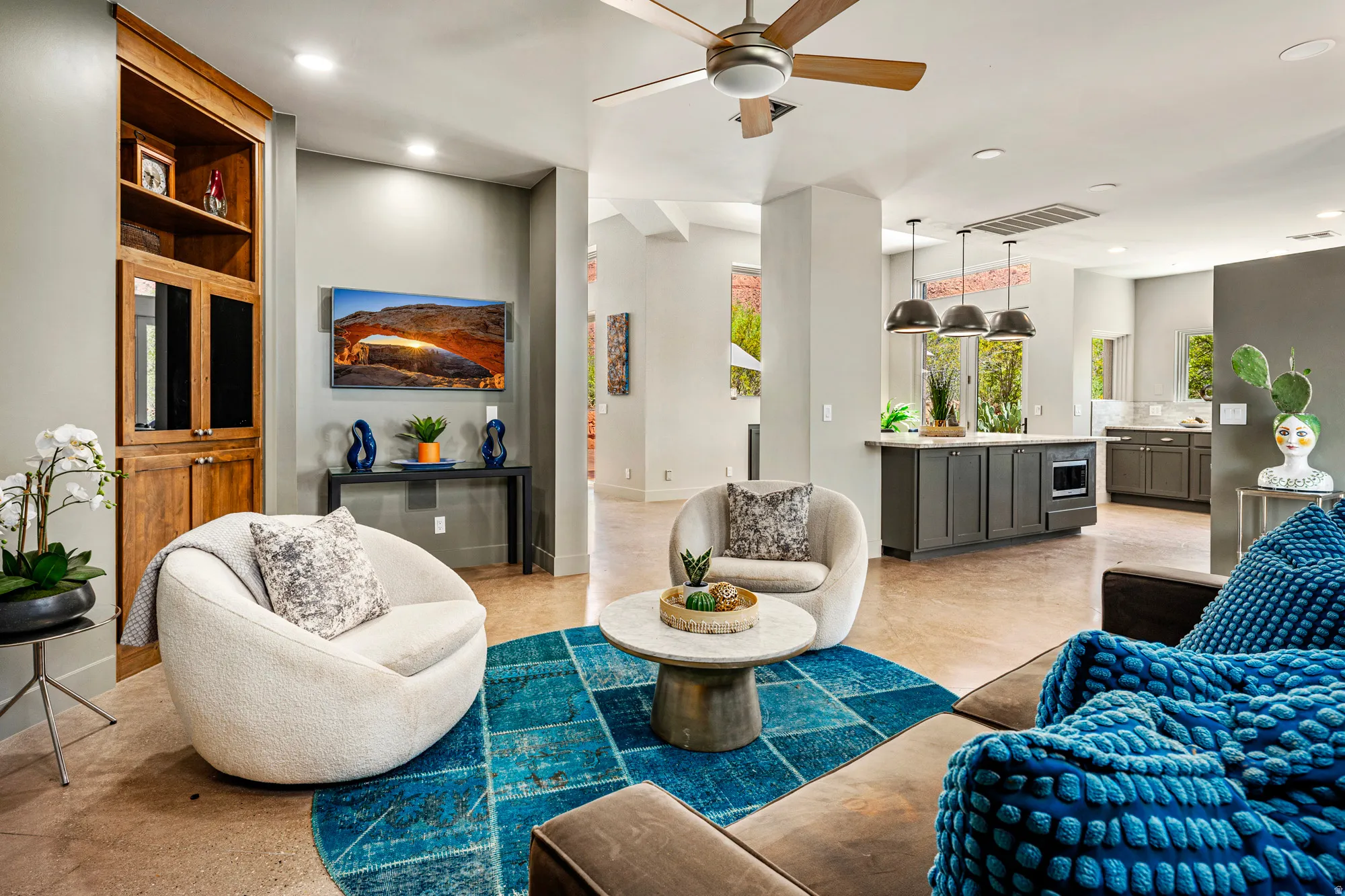 Open-concept living area with concrete flooring, a ceiling fan, and recessed lighting