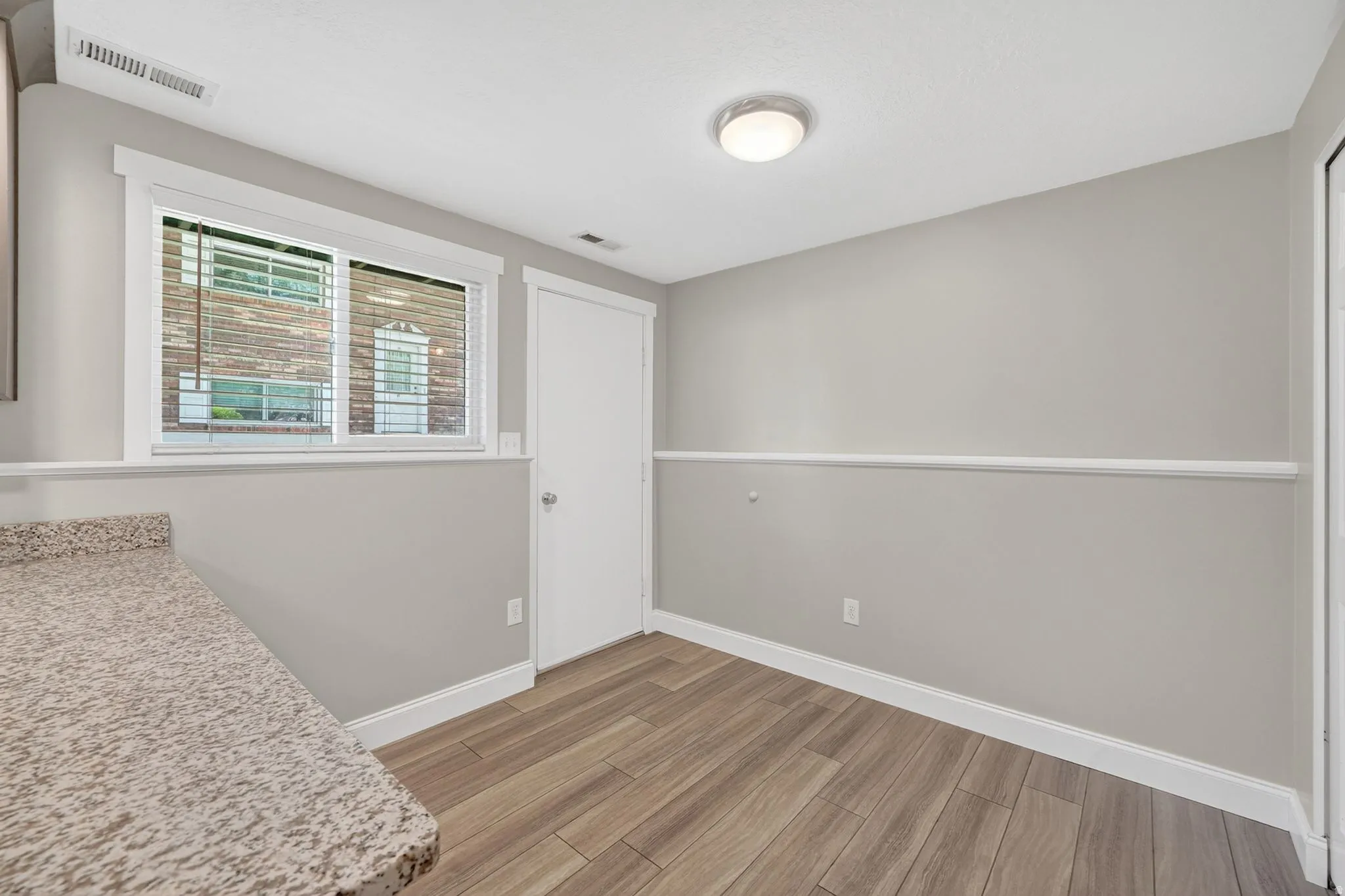 Interior room with light gray walls and white chair rail molding