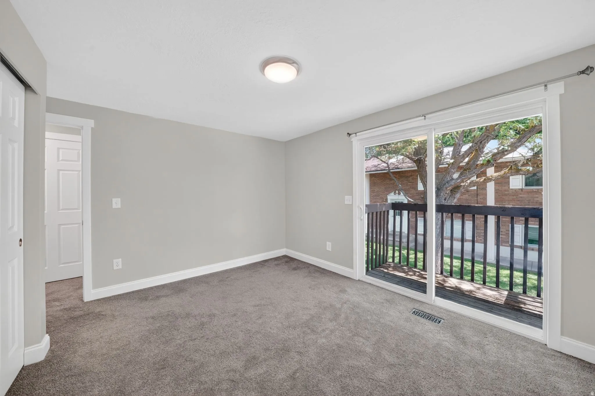 Carpeted room with light grey walls and white trim
