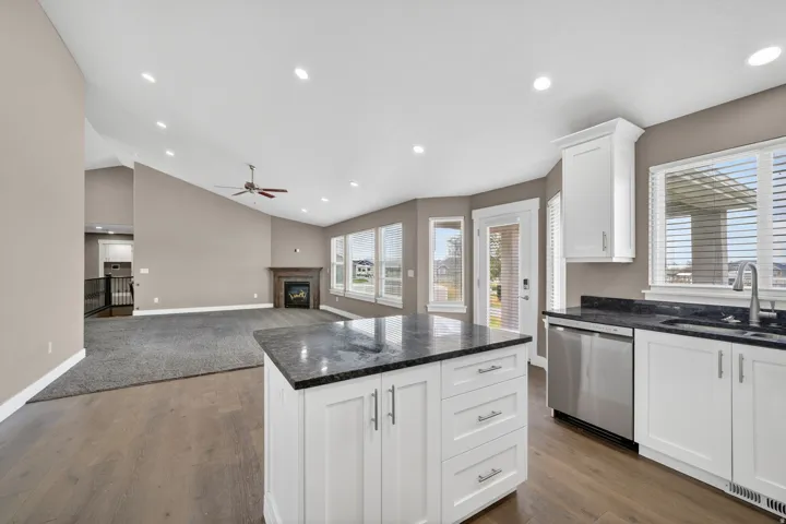 Kitchen island with dark countertop and white cabinetry