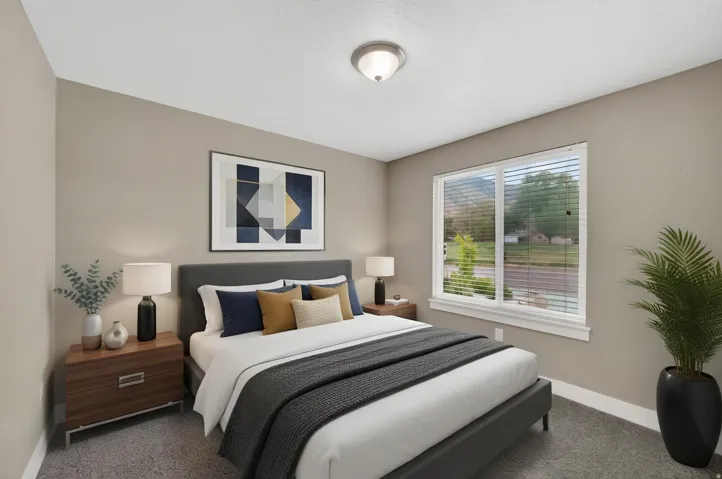 Bedroom featuring neutral wall tones, textured carpeting, a large window with blinds, and a semi-flush mount ceiling light fixture