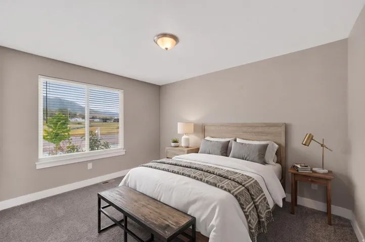 Bedroom featuring a large window, neutral wall paint, and gray carpet flooring