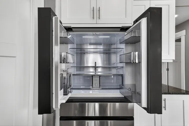 Stainless steel refrigerator with a French door design and bottom freezer drawer
