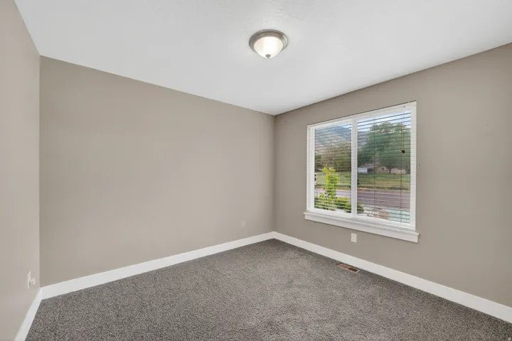 Neutral-toned walls complement the gray carpeting