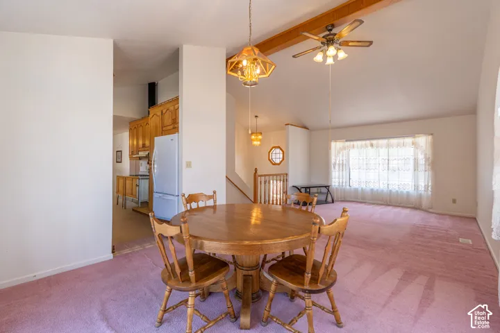 Open-concept common area featuring vaulted ceilings with exposed wood beams, a ceiling fan, and recessed lighting