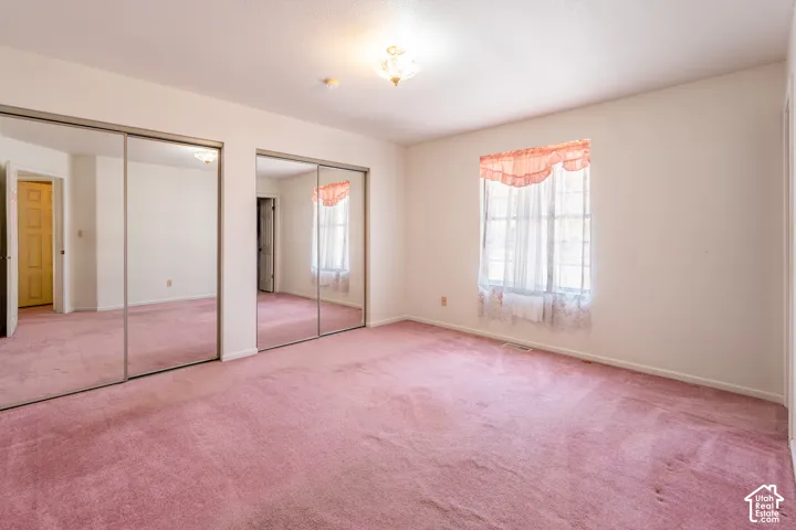 Spacious room featuring wall-to-wall carpeting and neutral wall tones
