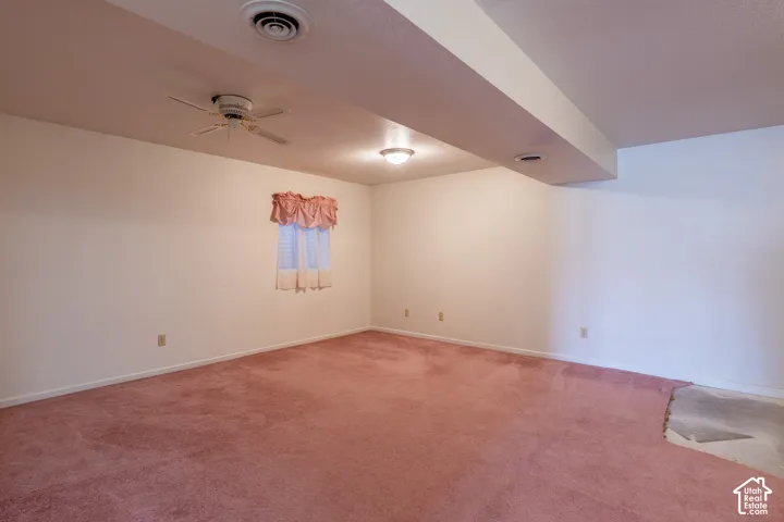Spacious room featuring pink carpeting, a window, a ceiling fan, and recessed lighting