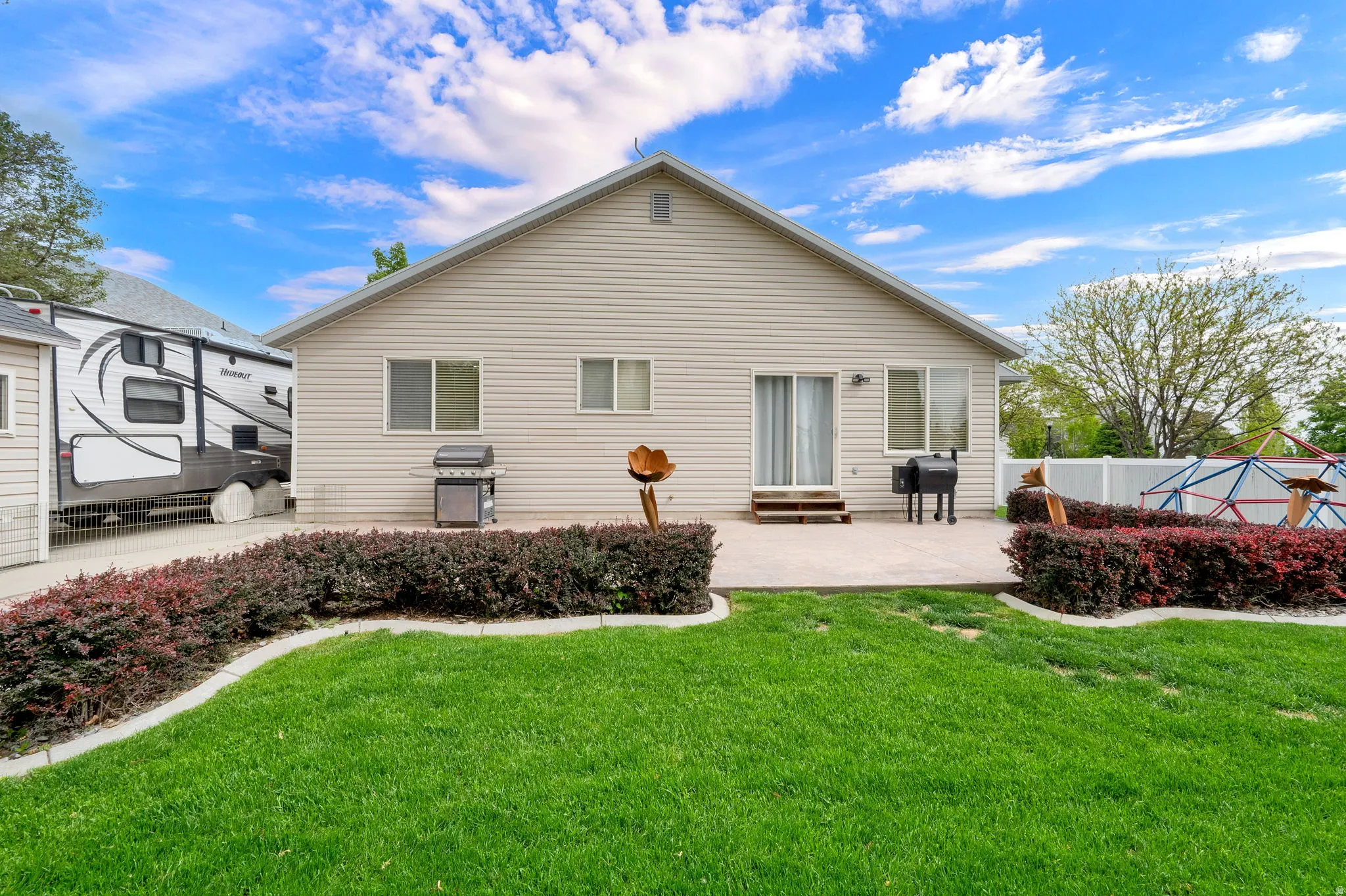 Rear exterior featuring horizontal siding and a concrete patio