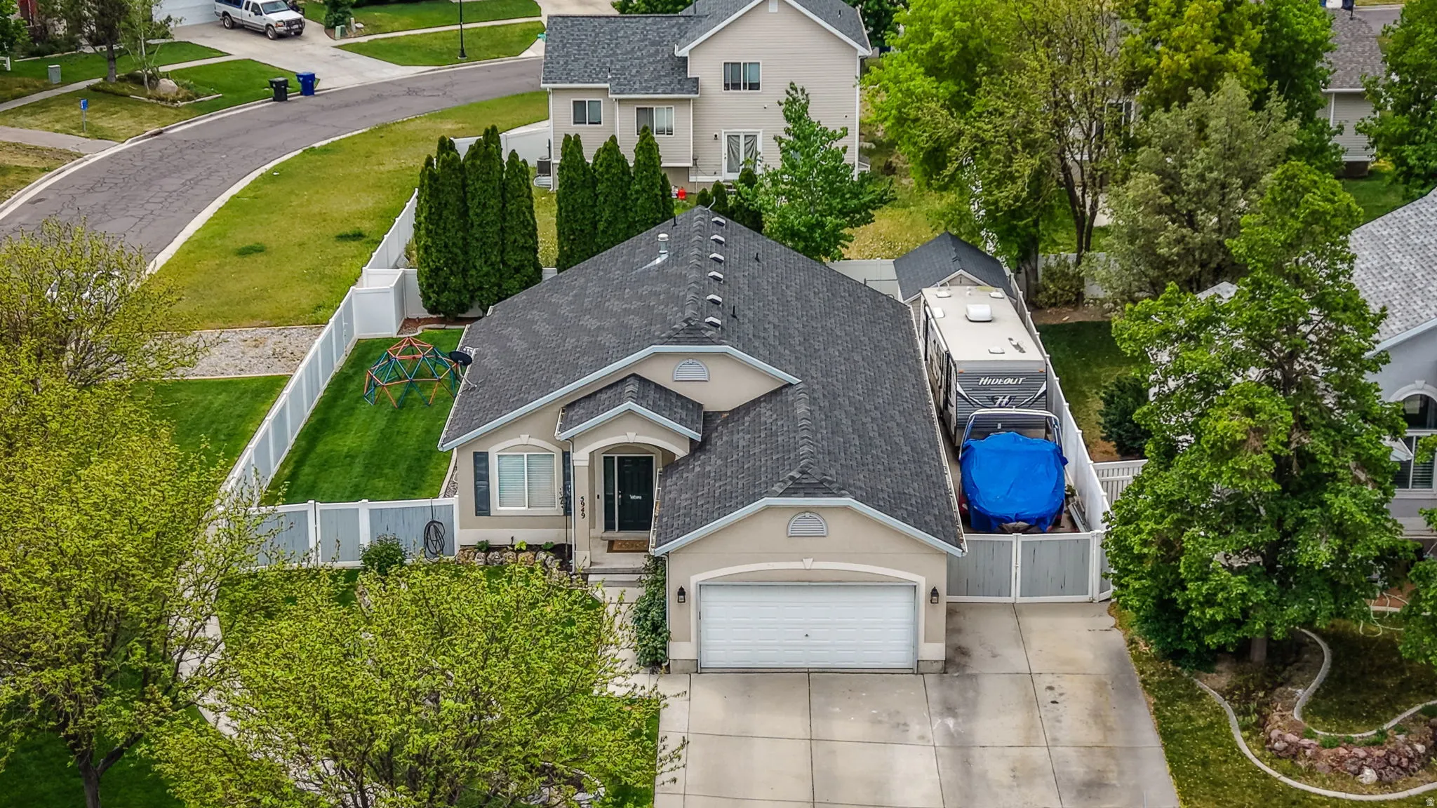 Single-story residence featuring a dark shingle roof and a two-car garage