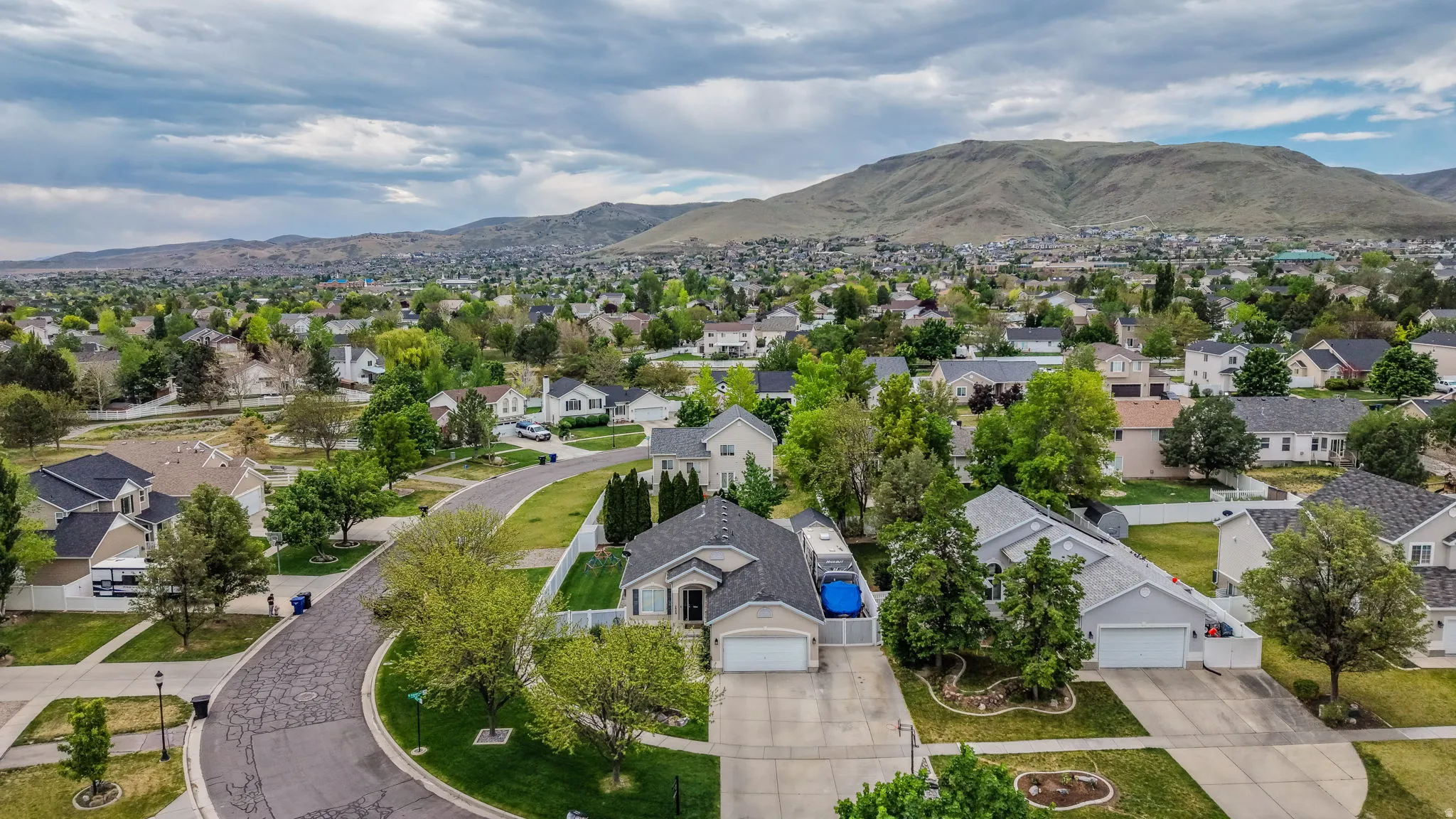 Aerial perspective showcasing a residential neighborhood with mountain backdrop