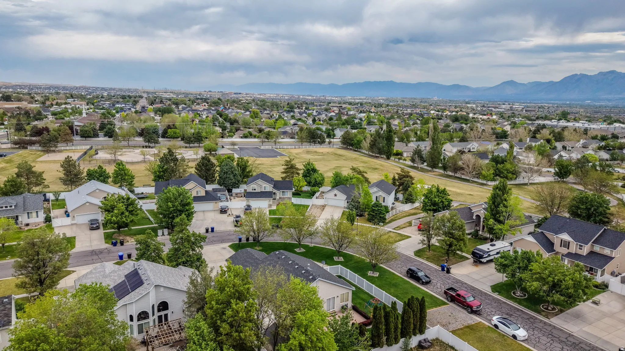 Expansive residential area featuring numerous single-family homes with diverse architectural styles, mature landscaping, and well-maintained streets
