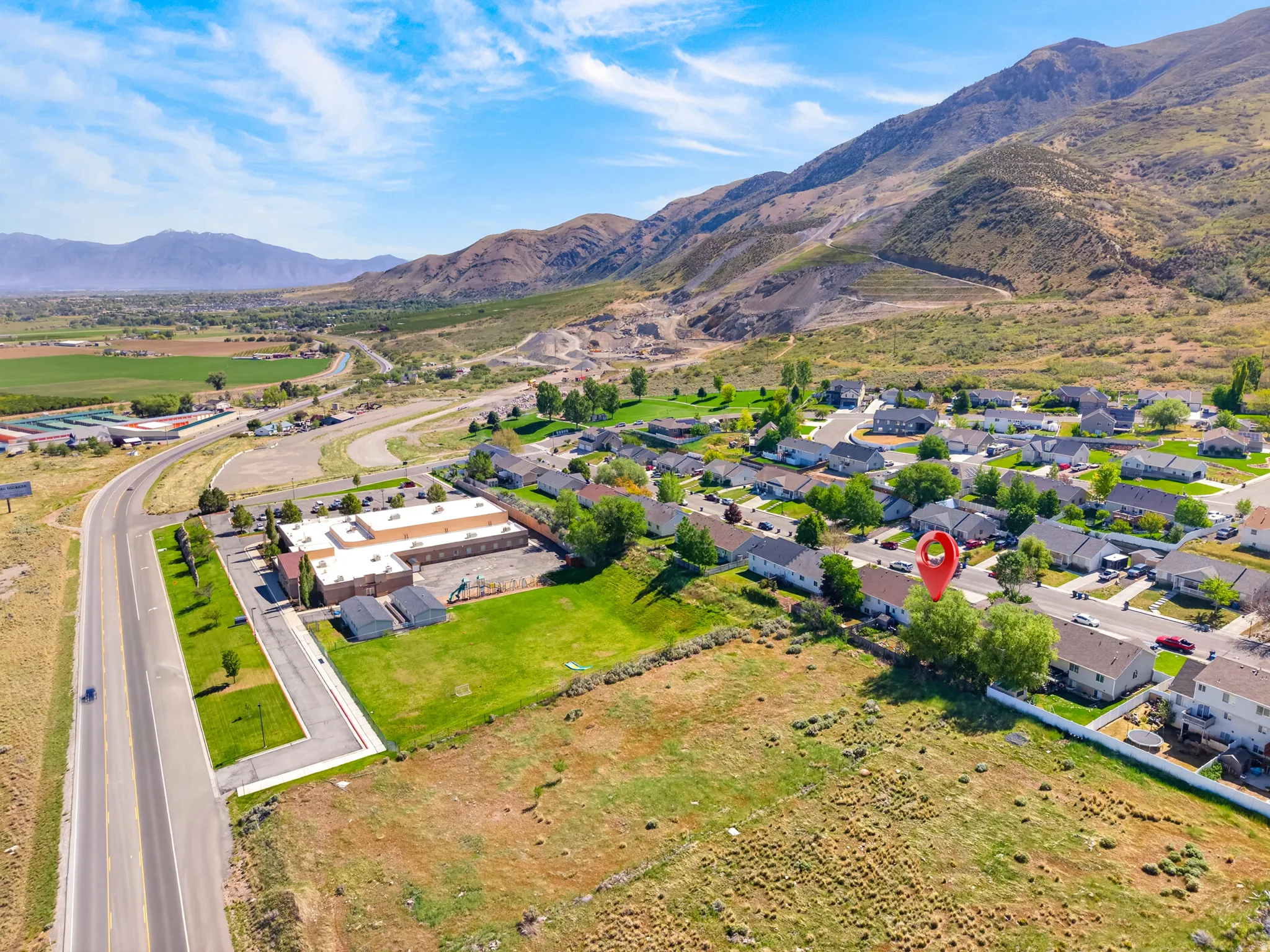 Aerial perspective showcasing residential properties nestled at the base of a mountain range