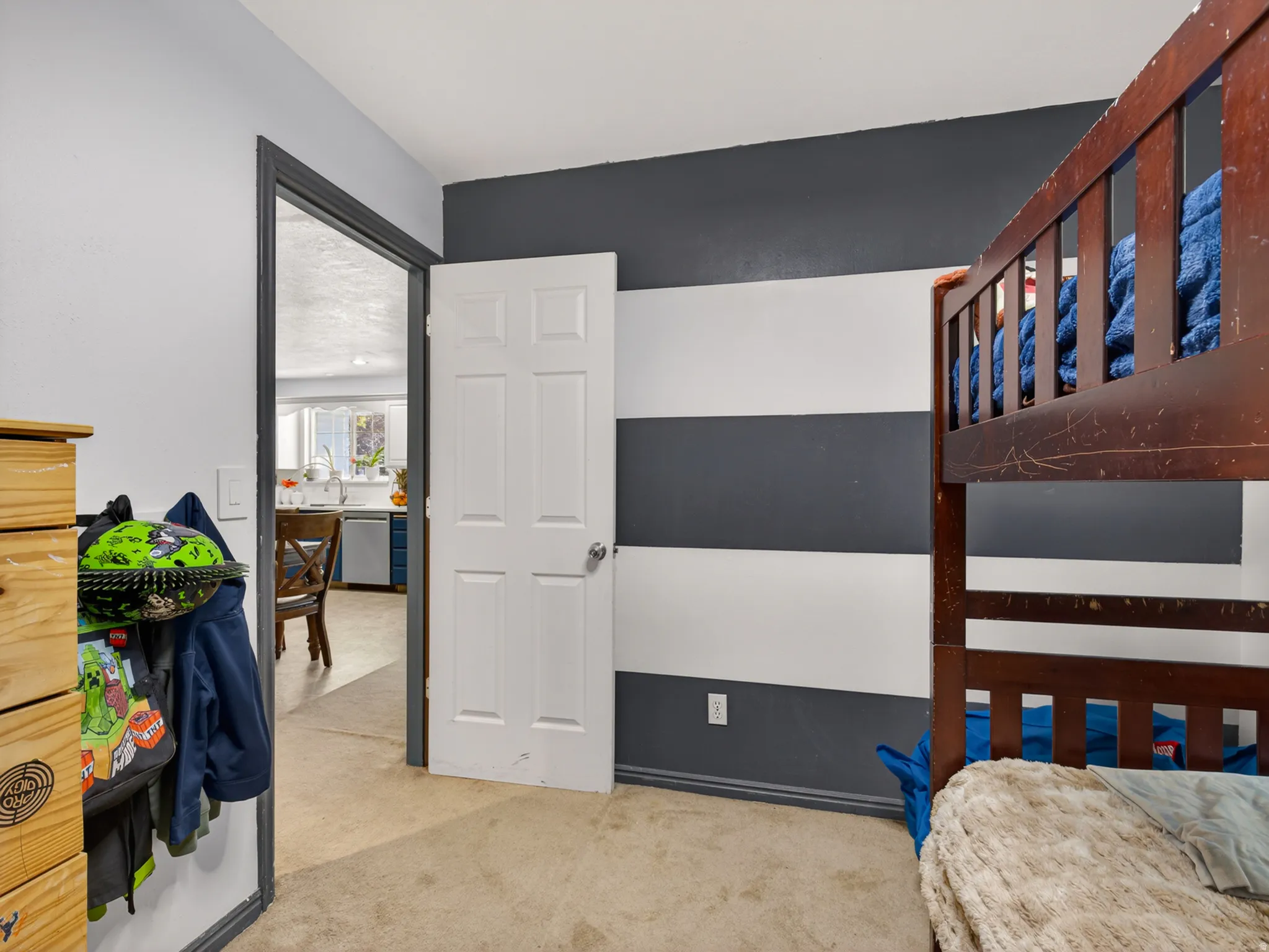 Main floor bedroom featuring striped accent wall