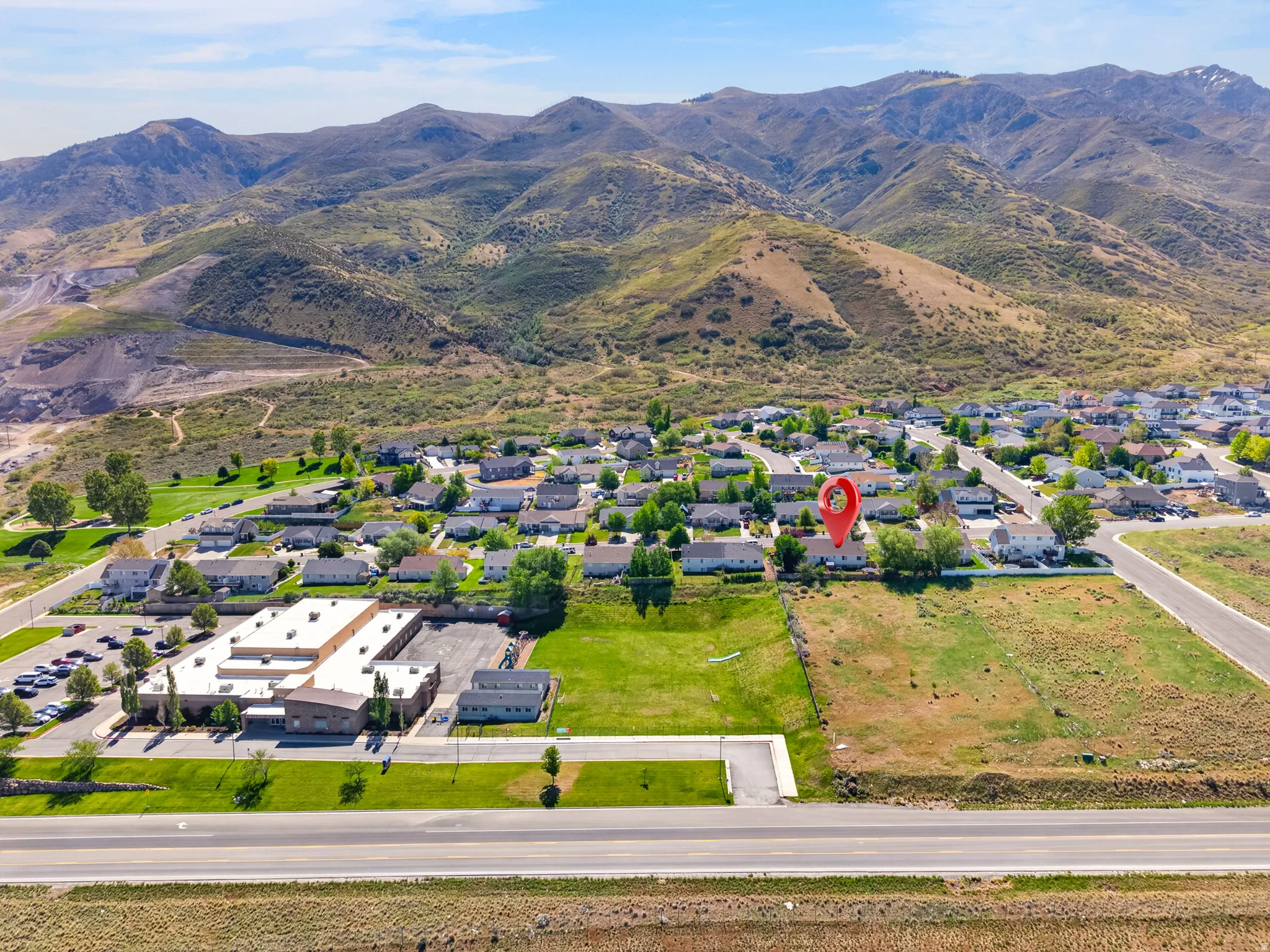 Aerial perspective showcasing a residential neighborhood against a mountainous backdrop