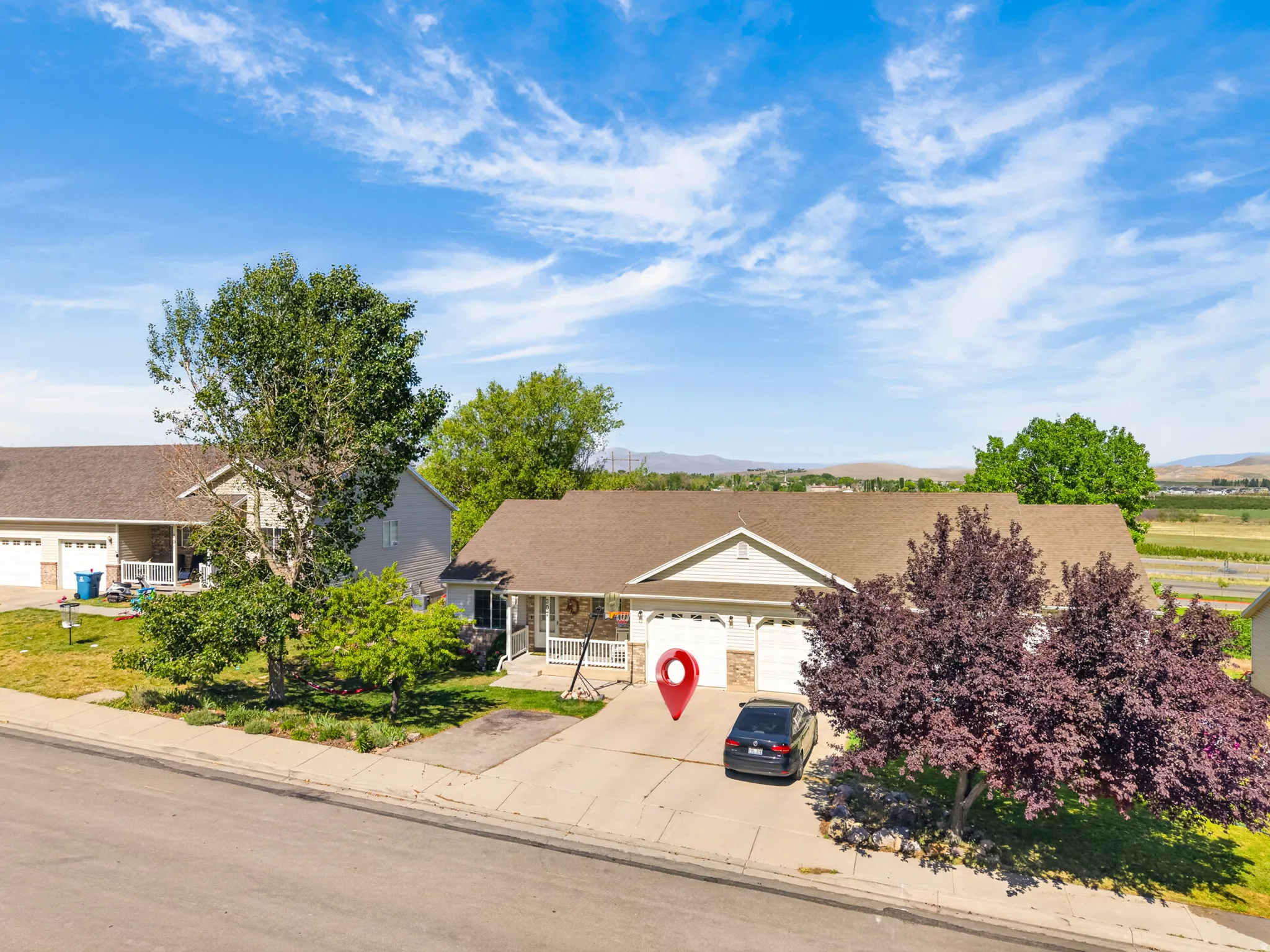 Twin home featuring a one-car (tandem) garage, concrete driveway, and front yard landscaping