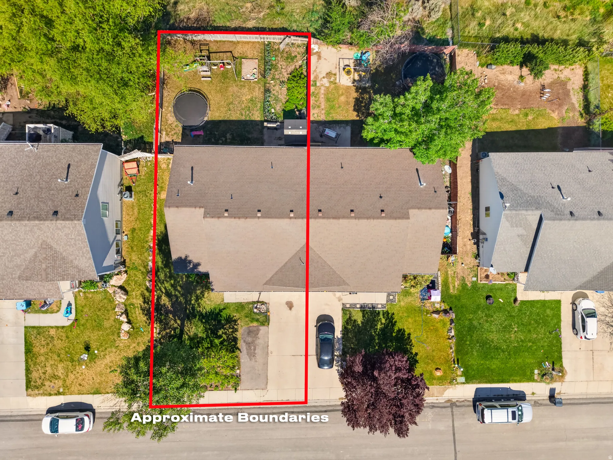 Aerial view showcasing the property with a private driveway, a two-story residence, and a spacious rear yard