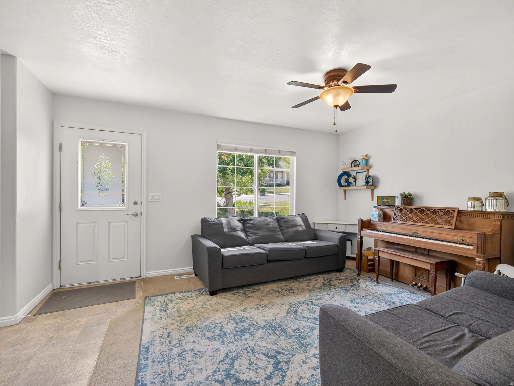Living space featuring light-toned walls and carpet flooring