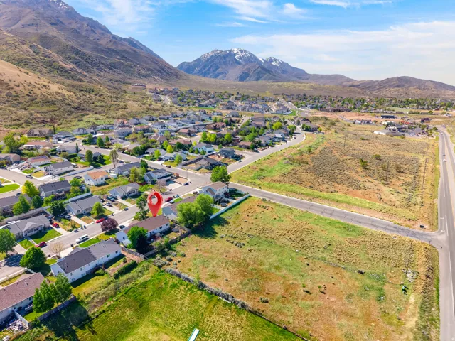Expansive aerial view showcasing a residential neighborhood with mountain backdrop