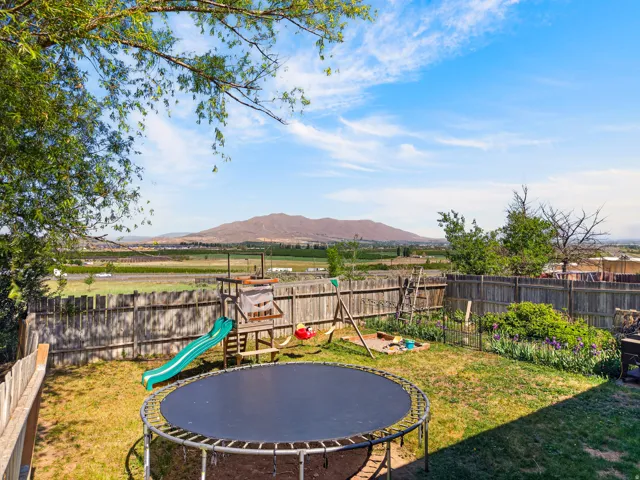 Expansive backyard with a wood privacy fence and mountain backdrop