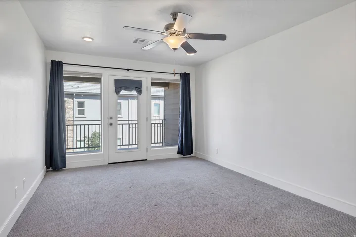 Bedroom with light gray carpeting and white walls