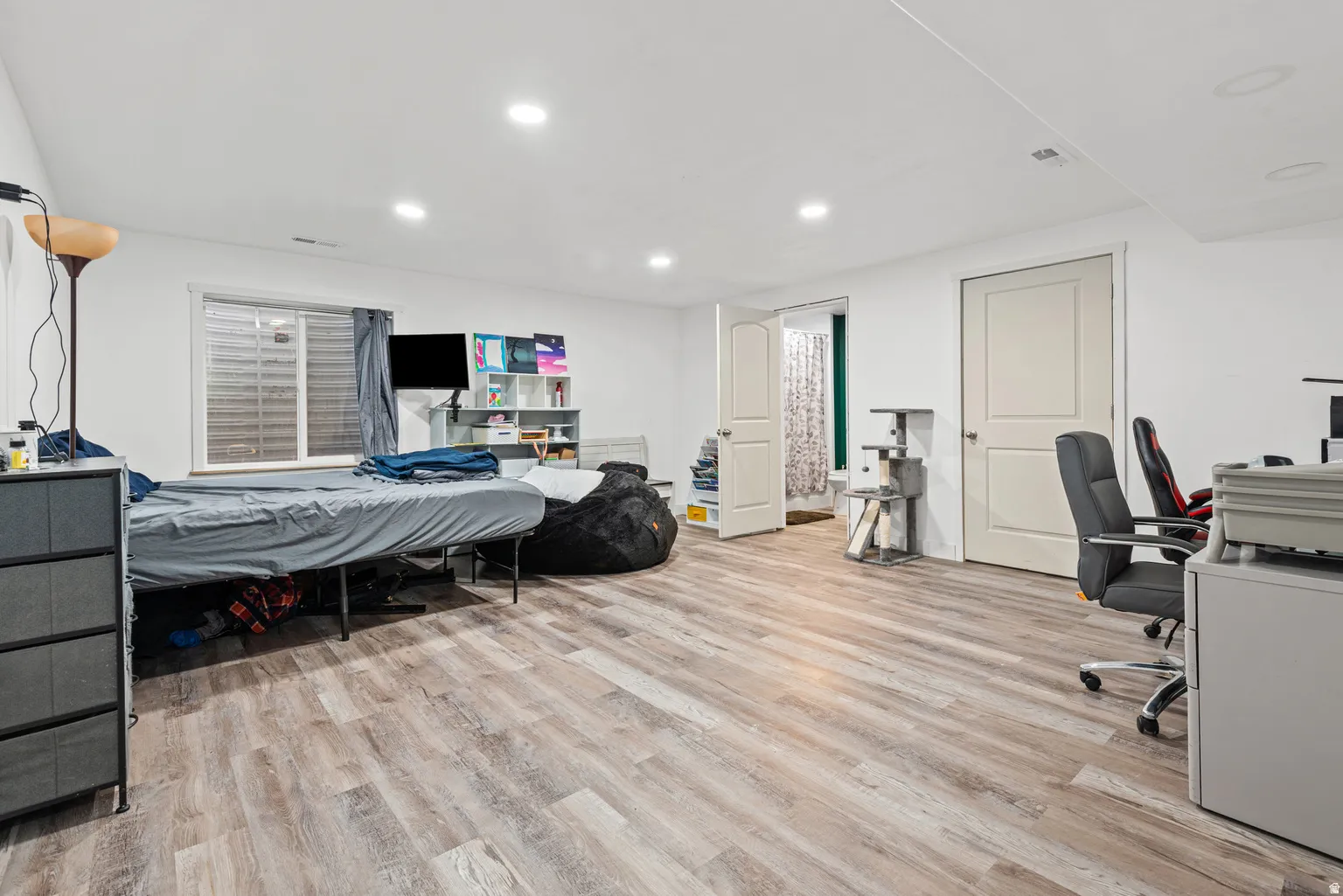 Open-concept room featuring wood-finish flooring and recessed lighting
